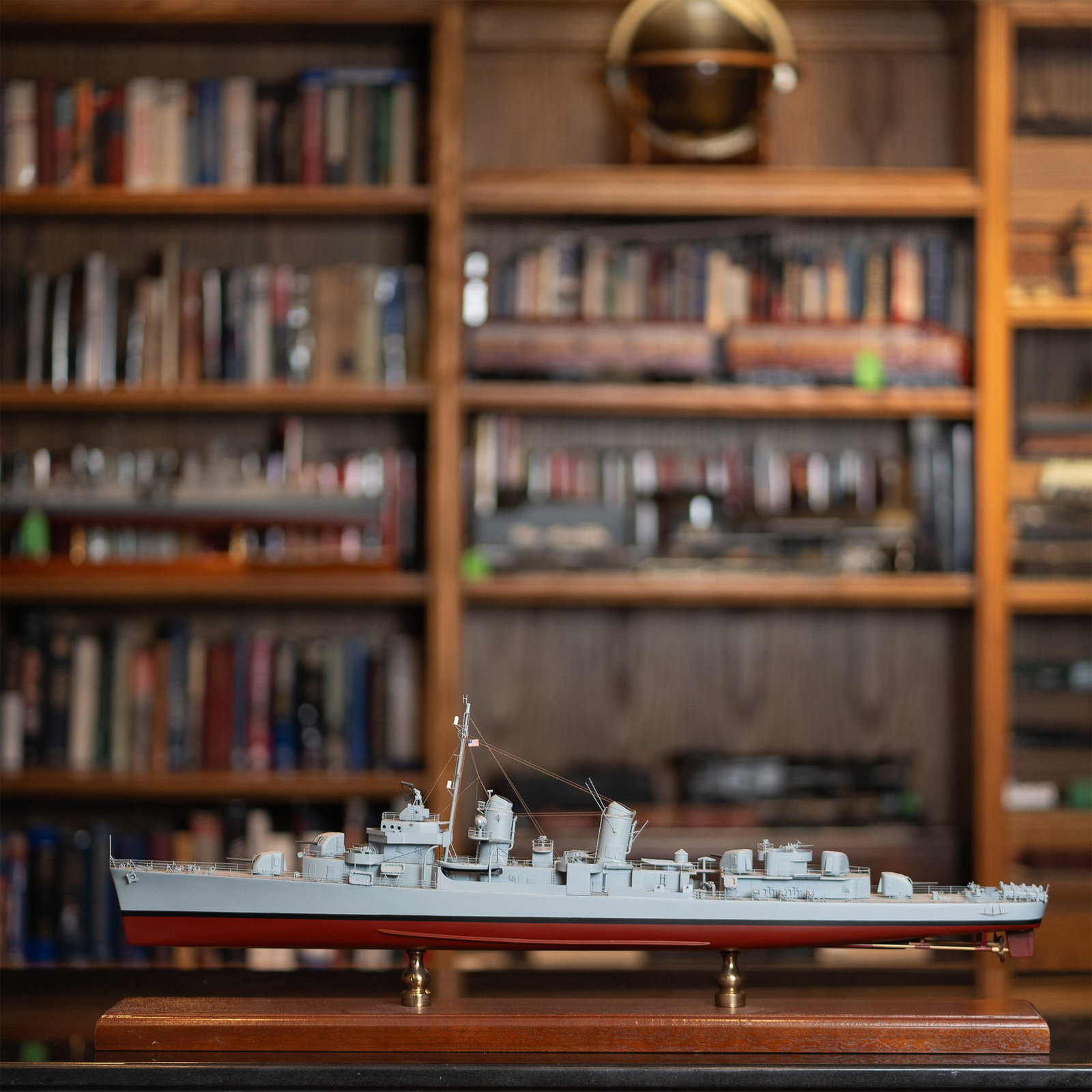 Model Ship of U.S. Navy Destroyer on Custom Wooden Base: This is a meticulously crafted scale model of a U.S. Navy destroyer, mounted on a polished wooden base with brass supports. Designed with incredible attention to detail, this model showcases the vesse