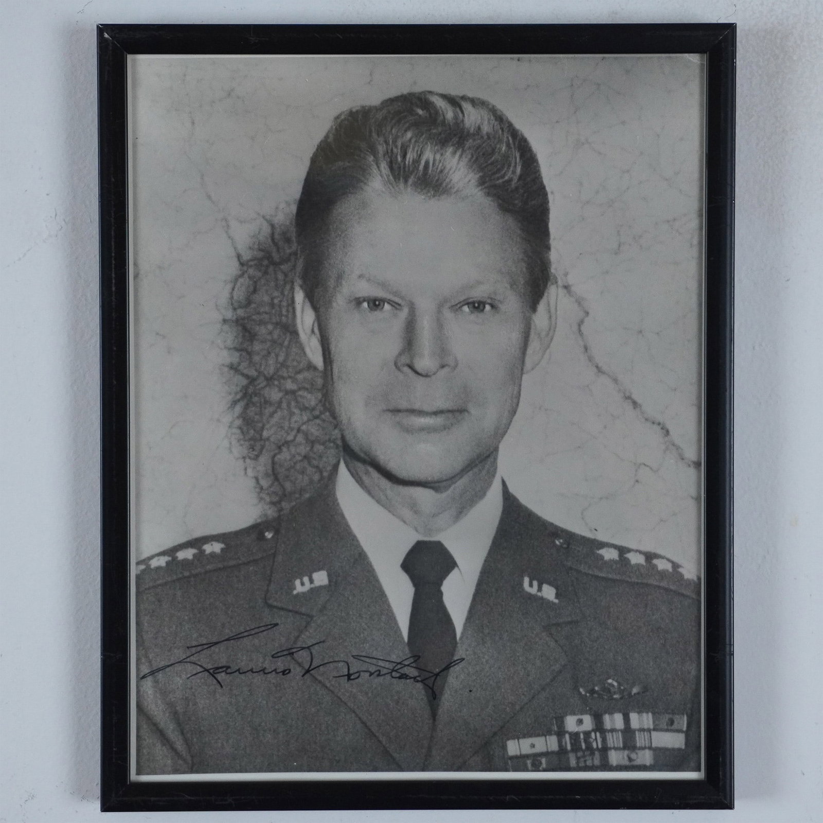 Autographed B&W Photograph of General Lauris Norstad: This autographed black and white photograph features General Lauris Norstad, a prominent United States Air Force officer and NATO Supreme Allied Commander Europe from 1956 to 1963. Collectible for mil