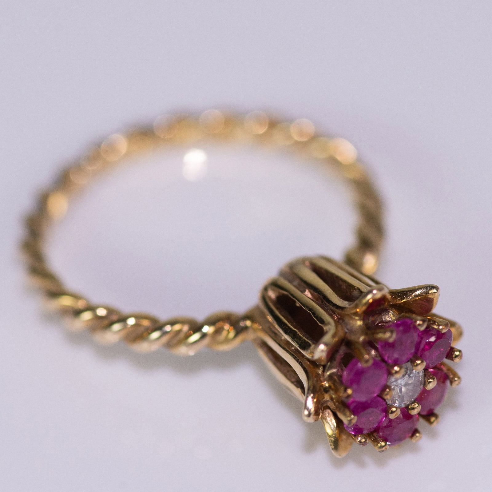 Delicate 14K Yellow Gold, Diamond and Amethyst Ring: Beautiful floral design ring in 14K gold with 0.50ct amethysts and one diamond in the center. Weight 3.28 grams. Size 7. Note: this listing is for 1 ring only, the last photo is just an example of how