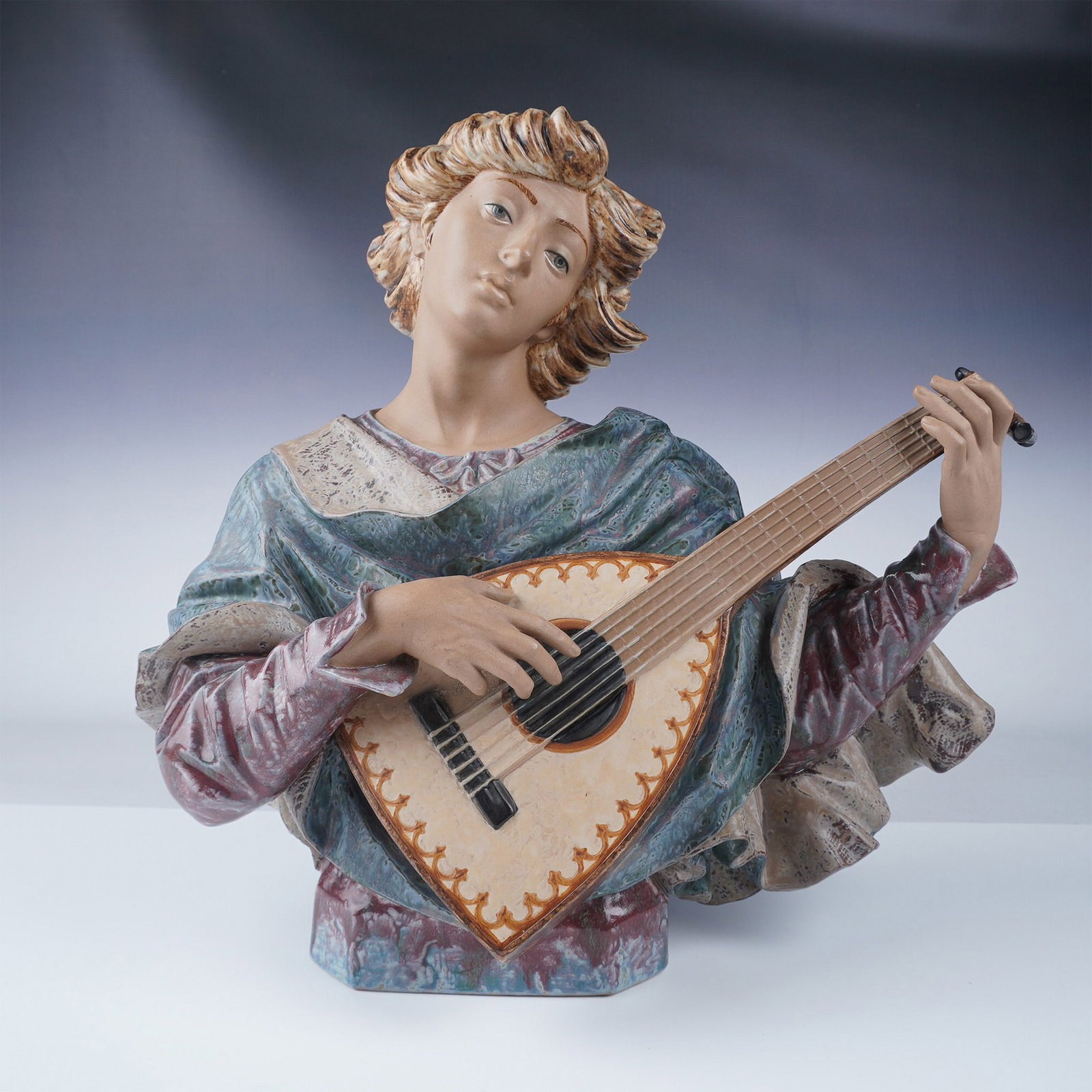 Lladro Porcelain Figurine, Troubador 1014943: This exquisite Lladro porcelain figurine titled Troubador showcases a romantic musician playing a lute. The figurine features intricate detailing, from the musician's flowing tunic to the delicately c