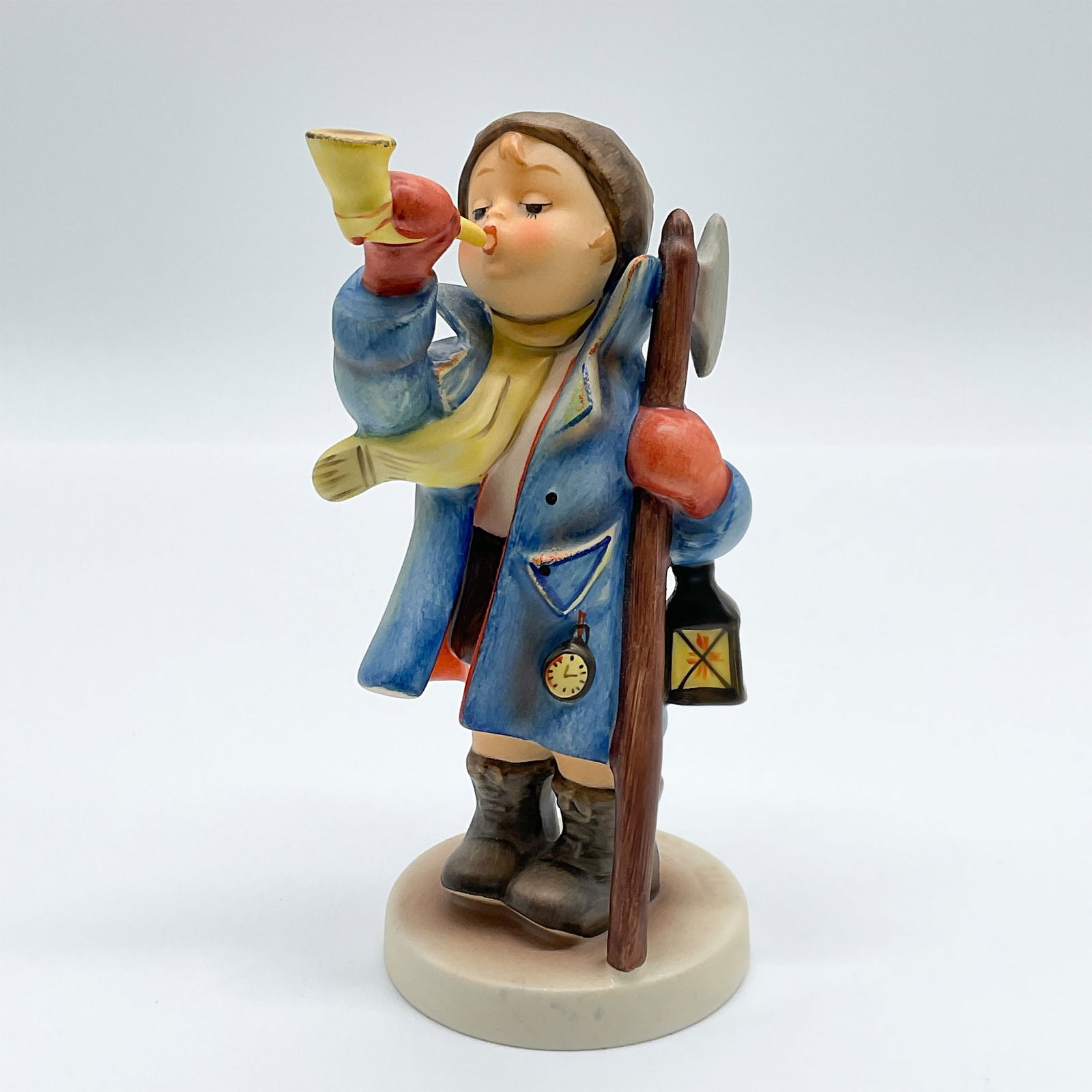 Goebel Hummel Porcelain Figurine, Hear Ye Hear Ye: Delightful Goebel Hummel porcelain figurine titled Hear Ye Hear Ye, model number 15/O. This figurine features a young night watchman blowing a horn while holding a lantern and staff, dressed in a blue
