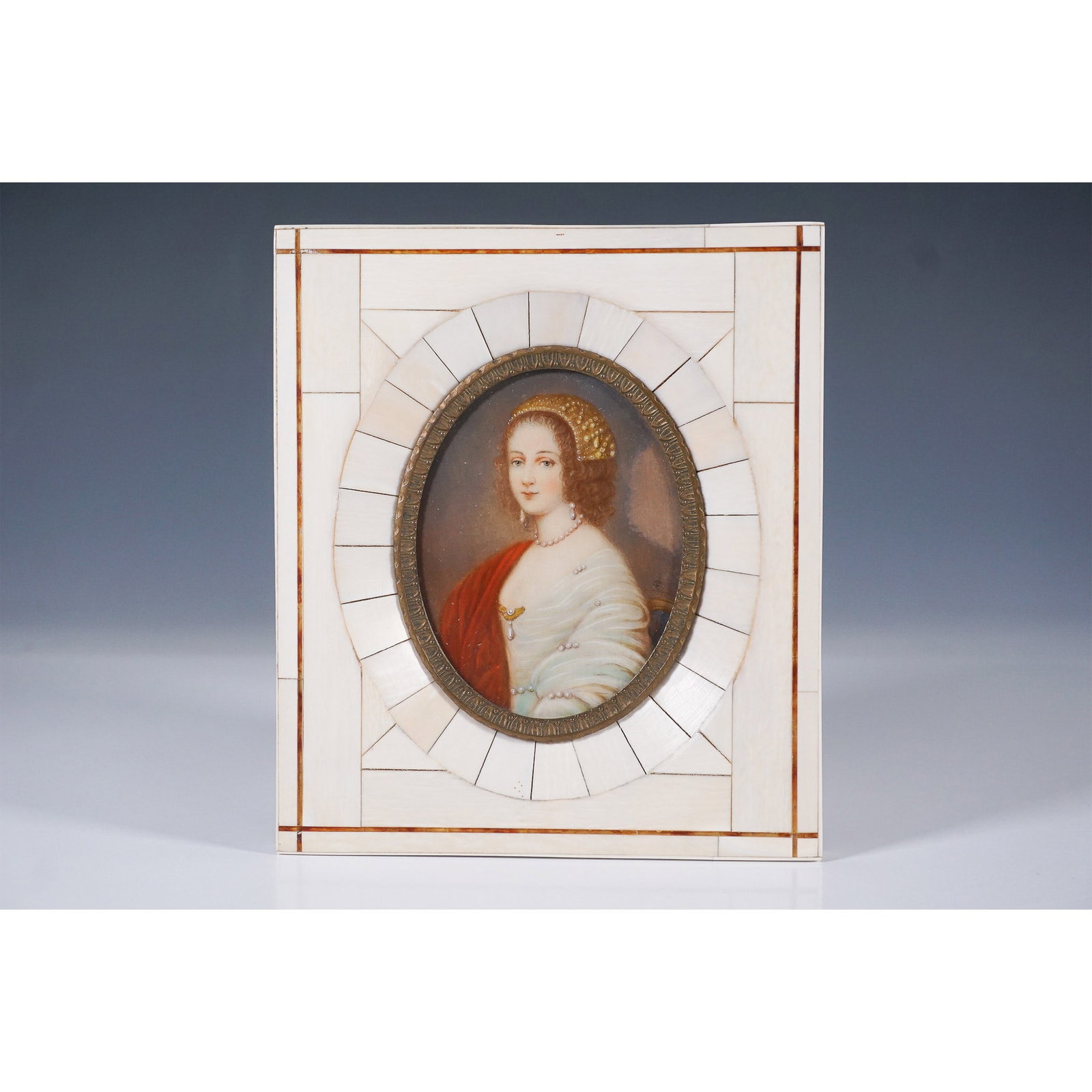 Miniature Portrait of a Noblewoman in Bone Frame: A finely crafted miniature portrait of a noblewoman, displayed in an intricately inlaid bone frame. The portrait captures a young woman adorned in an elegant white garment with pearl accents and a red