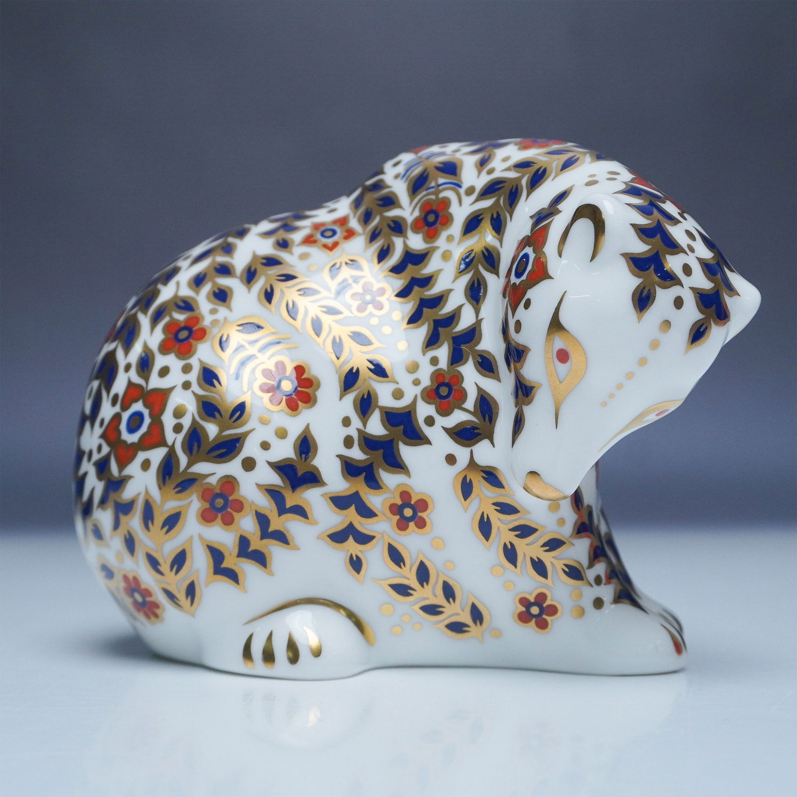 Royal Crown Derby Paperweight Russian Bear: Elegant Royal Crown Derby Russian Bear paperweight, crafted from fine bone china and featuring the brand's signature Imari pattern. The exquisite design showcases intricate floral and foliate motifs i
