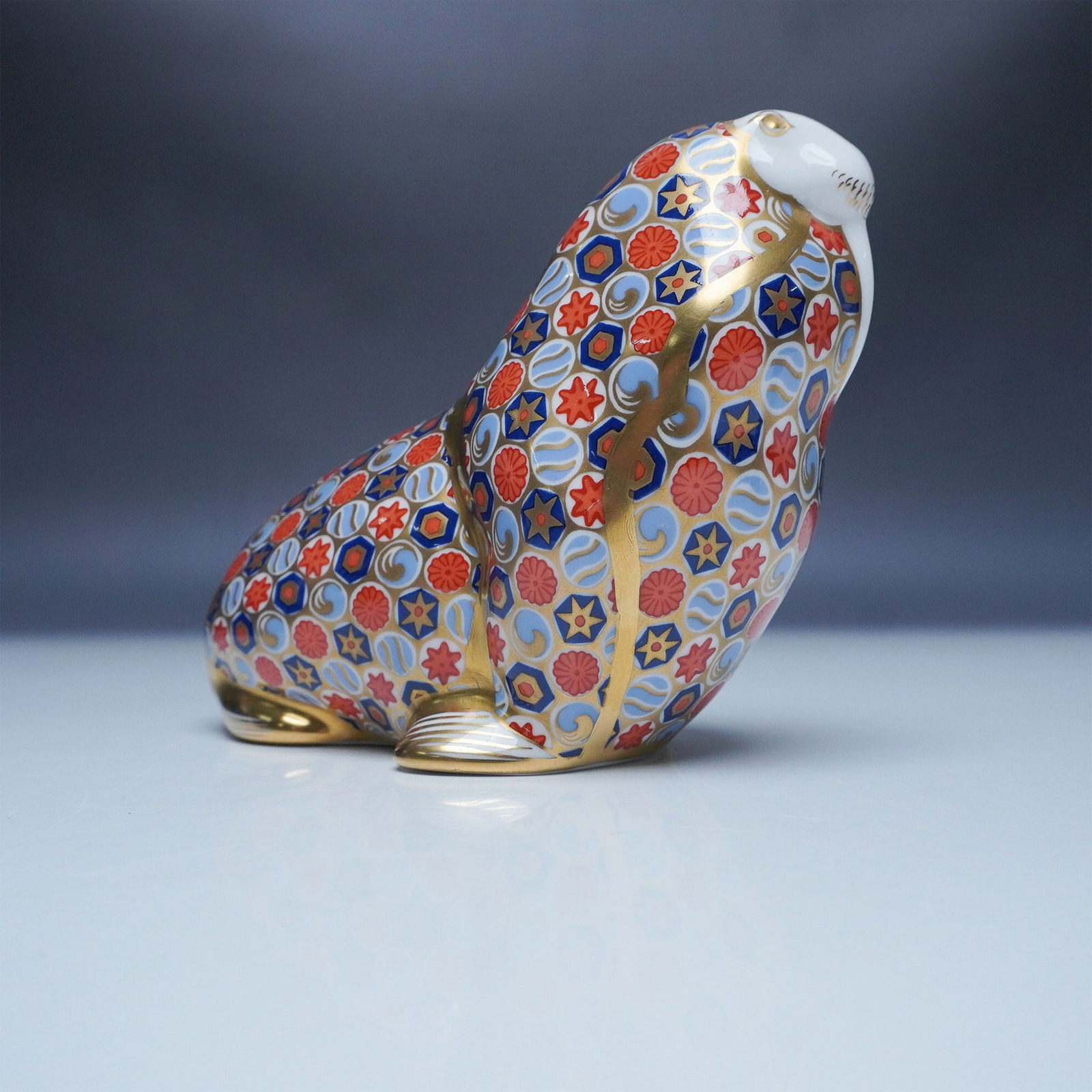 Royal Crown Derby Walrus Paperweight: Royal Crown Derby porcelain paperweight titled Walrus, decorated in the brand's signature Imari palette with intricate geometric and floral patterns in cobalt blue, red, and gold. Accentuated with ric