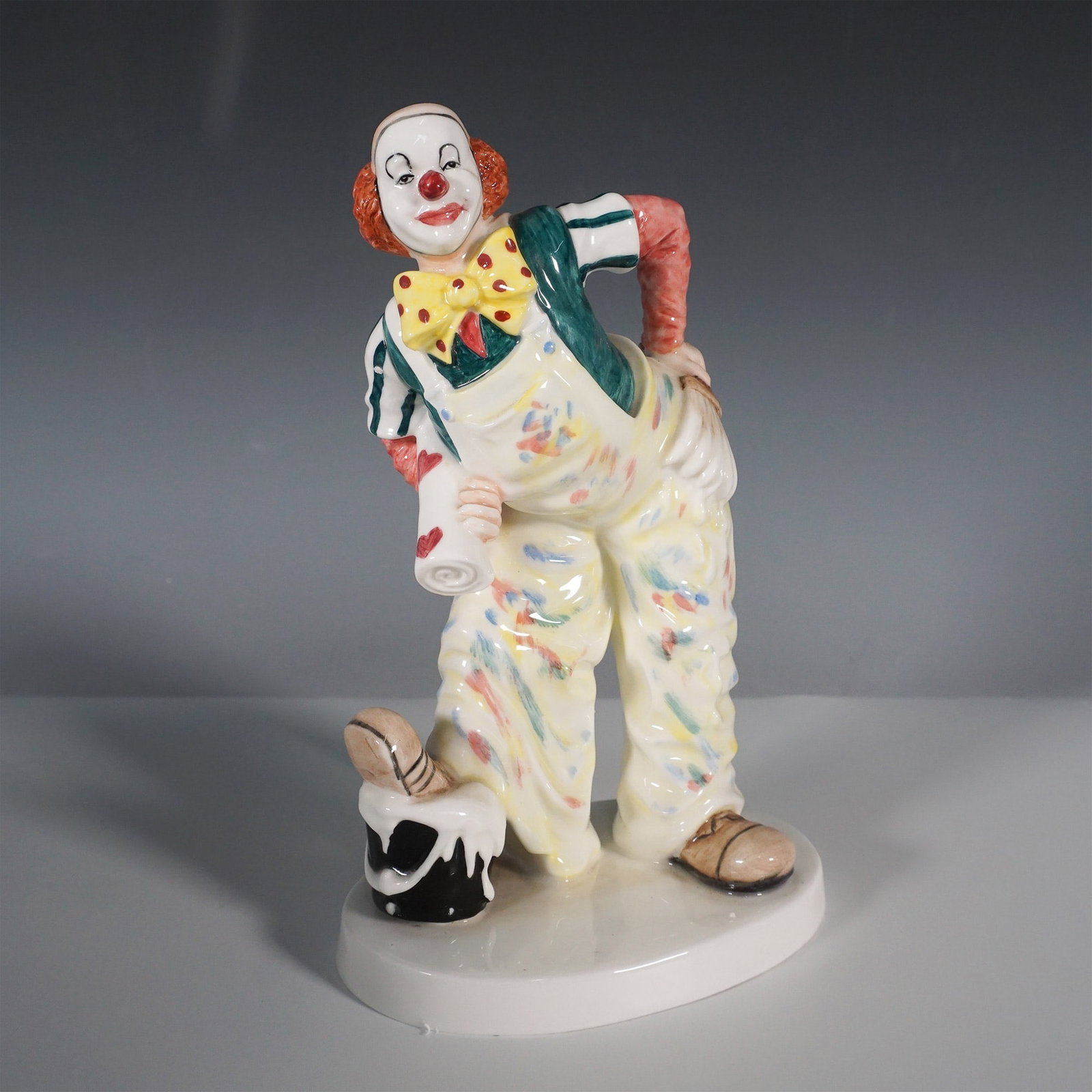Coalport Cavalcade of Clowns Auguste Mishap Figurine: A whimsical Coalport fine bone china figurine titled Auguste's Mishap from the Cavalcade of Clowns series. This lively piece captures a mischievous clown in his classic attire, complete with suspender