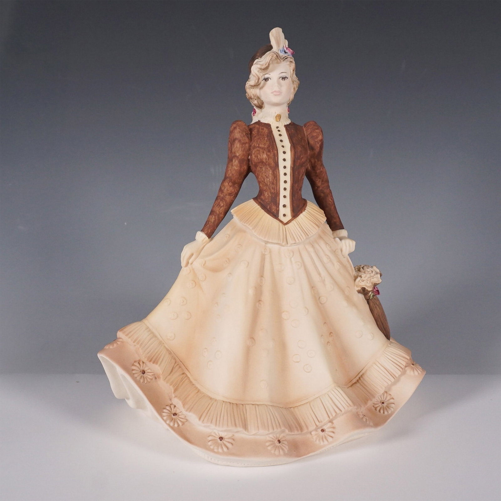 Coalport Age of Elegance "Autumn Stroll" Porcelain Figurine: A finely detailed Coalport porcelain figurine titled Autumn Stroll from the Age of Elegance collection, hand-decorated and dated 1993. This graceful piece captures a Victorian-era lady in a flowing be