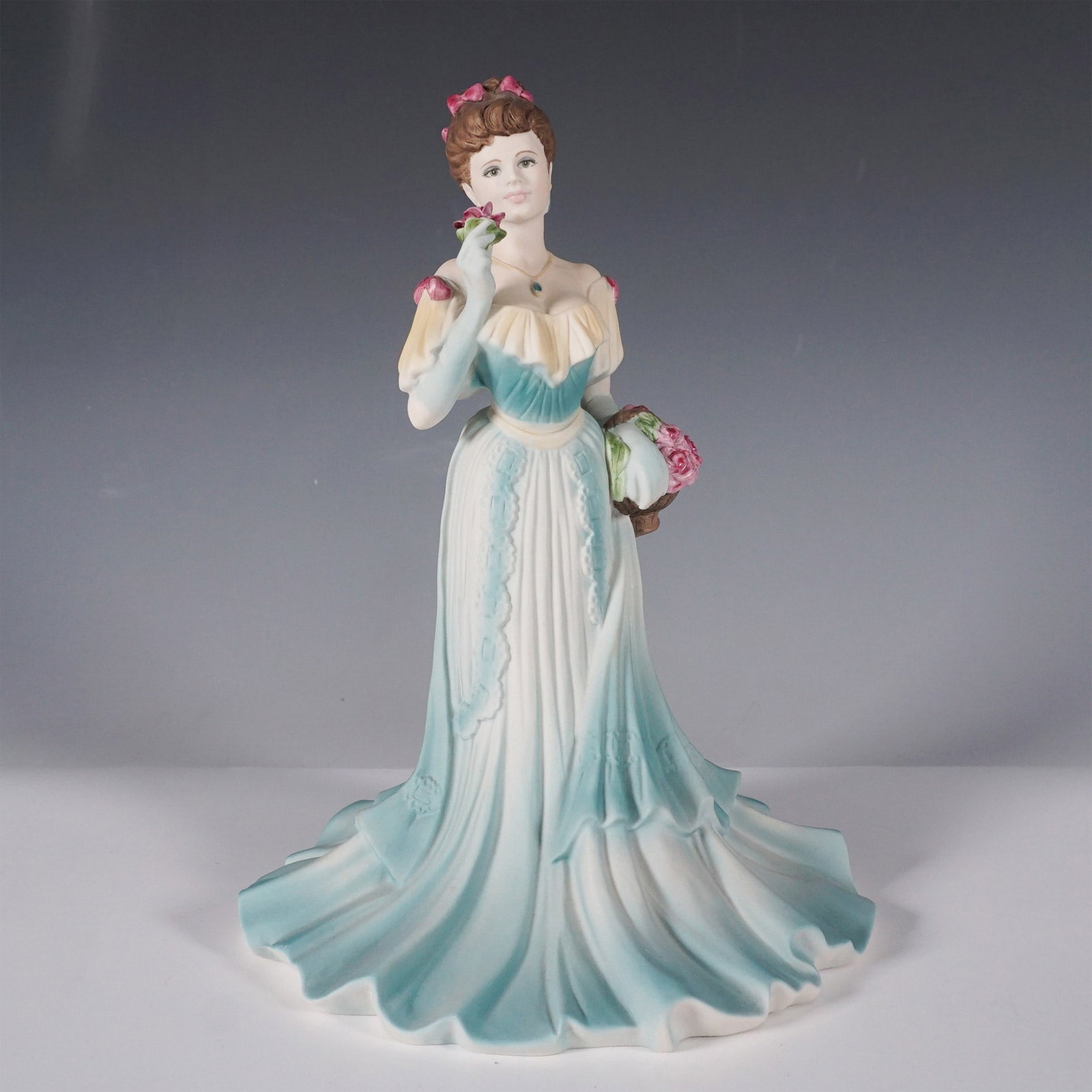 Coalport Age of Elegance Magnolia Parade Signed by A. Willis: Elegant Coalport figurine titled Magnolia Parade from the Age of Elegance collection. This beautifully hand-decorated porcelain sculpture features a graceful lady in a flowing ombre blue gown, accente