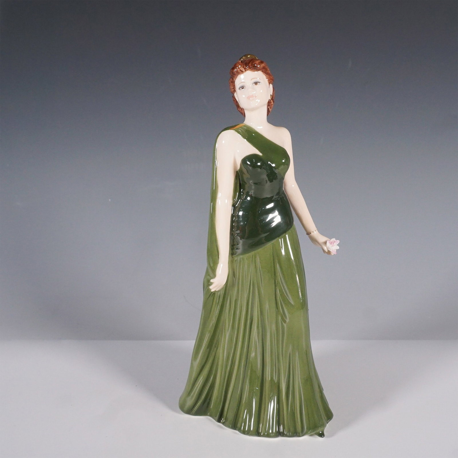 Coalport Ladies of Fashion Kate Figurine: Coalport Ladies of Fashion Kate figurine, a finely crafted bone china collectible from the esteemed English porcelain manufacturer. Hand-decorated and modeled by Karl J. Taylor, this elegant figurine 