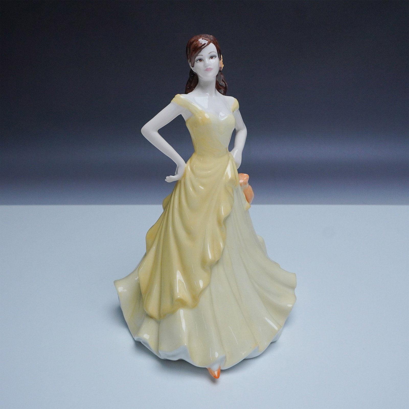 Coalport Sentiments Thinking of You Bone China Figurine: Elegant Coalport Thinking of You figurine from the Sentiments collection, crafted in fine bone china. This hand-decorated piece, modeled by Jack Glynn, features a graceful woman in a flowing yellow go