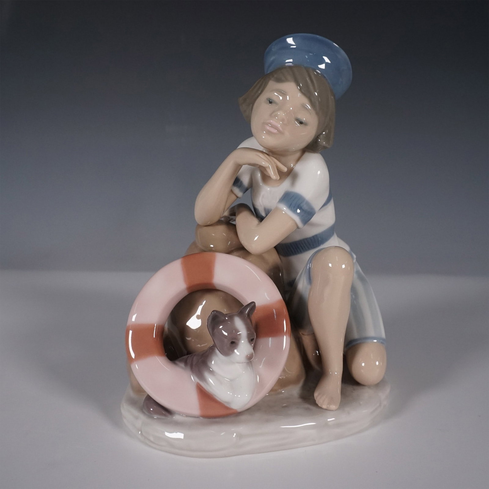 Lladro Figurine, Monday's Child, 6011: Presenting the charming Lladro figurine titled Monday's Child (Nino Lunes), model number 6011. Sculpted by Juan Huerta, this piece was issued in 1993 and retired in 1997. It features a young boy in sa