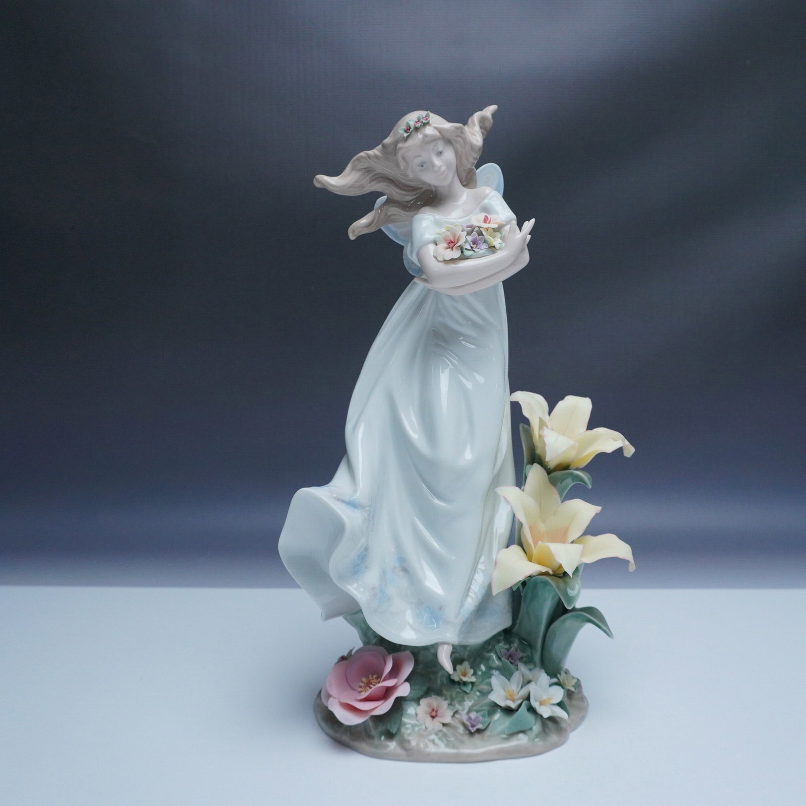 Lladro Porcelain Figurine, Mystical Garden 1006686: This exquisite Lladro figurine, titled Mystical Garden (No. 1006686), was designed by sculptor Francisco Nalanio and decorated by P. P?rez. Released in 2000, it features a graceful angel holding a bas