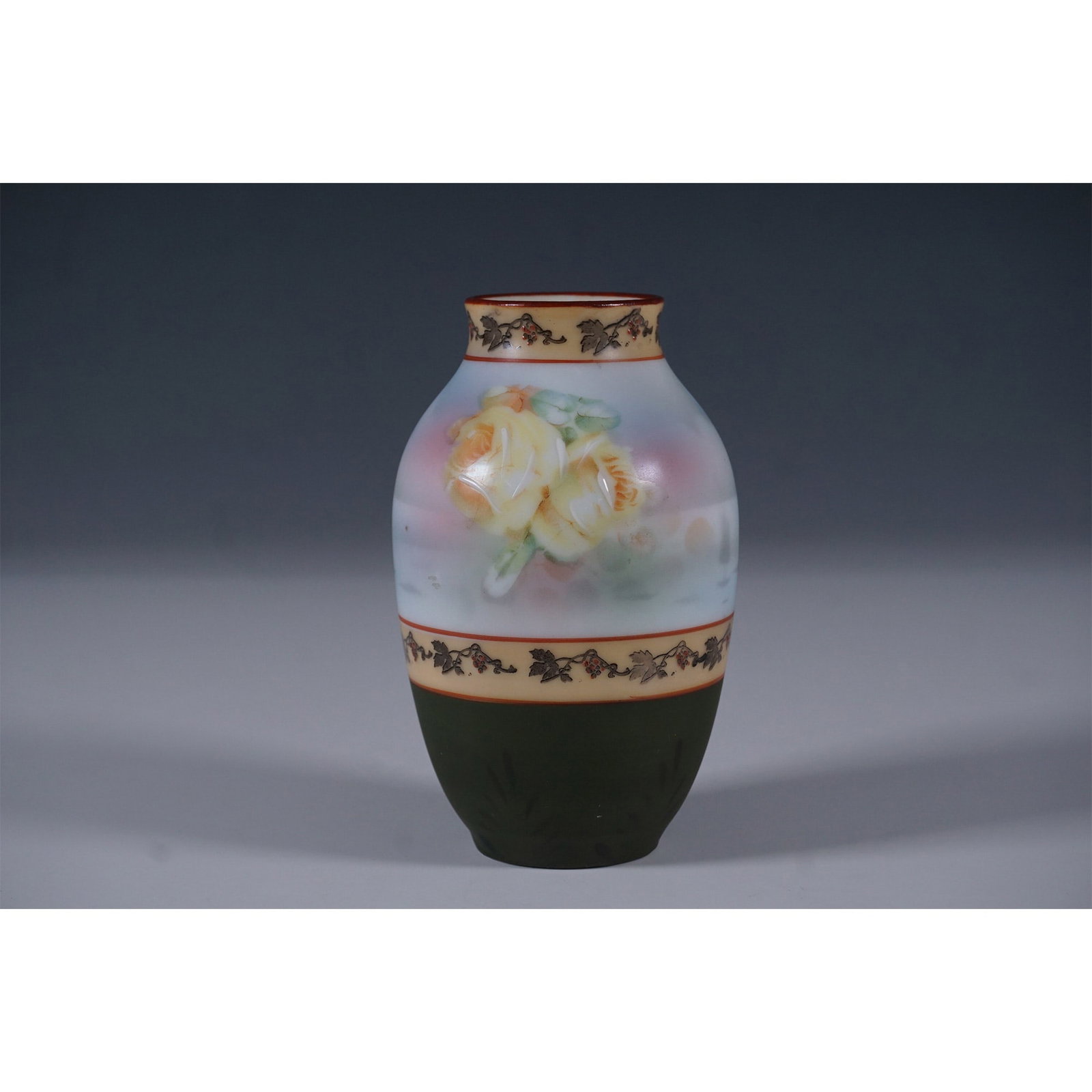 Royal Bayreuth Bavaria Hand-Painted Vase: A Royal Bayreuth Bavaria porcelain vase featuring hand-painted floral motifs with yellow roses against a soft pastel background. The vase is adorned with a decorative vine and berry border, separating