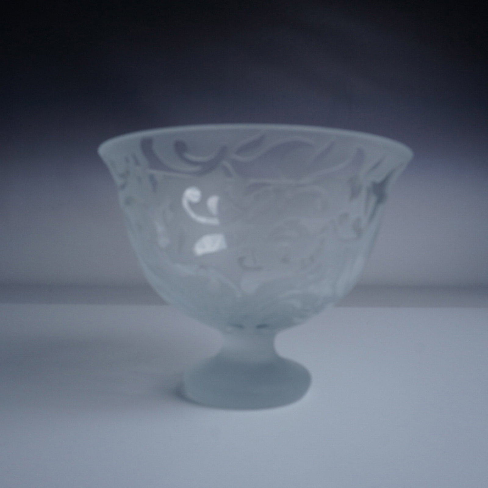 Michael Weems Elise-Clear Frosted Glass Pedestal Bowl: Michael Weems Elise-Clear frosted glass pedestal bowl featuring an intricate cutout pattern. This elegant piece measures 5.5"H x 7" in diameter and comes with its original presentation box, marked "Th