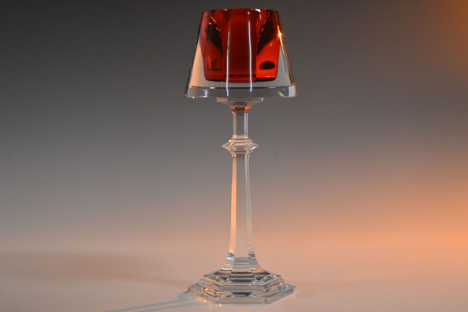 Baccarat Crystal Harcourt My Fire Candlestick Signed: This Baccarat Harcourt My Fire Candlestick, designed by Philippe Starck and signed by the designer, showcases the signature red Harcourt goblet encased in transparent crystal. The piece stands 12.6 in