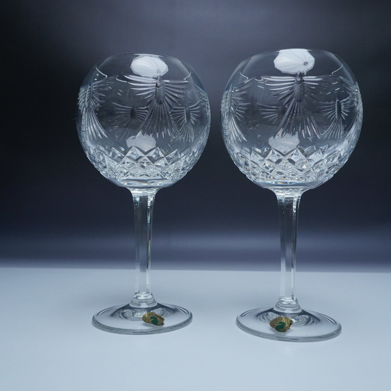 2pc Waterford Crystal Millennium Toasting Goblets - Peace: A pair of exquisite Waterford Crystal toasting goblets from The Millennium Collection. These goblets, crafted from the finest crystal, feature an intricate cut design that elegantly catches the light.