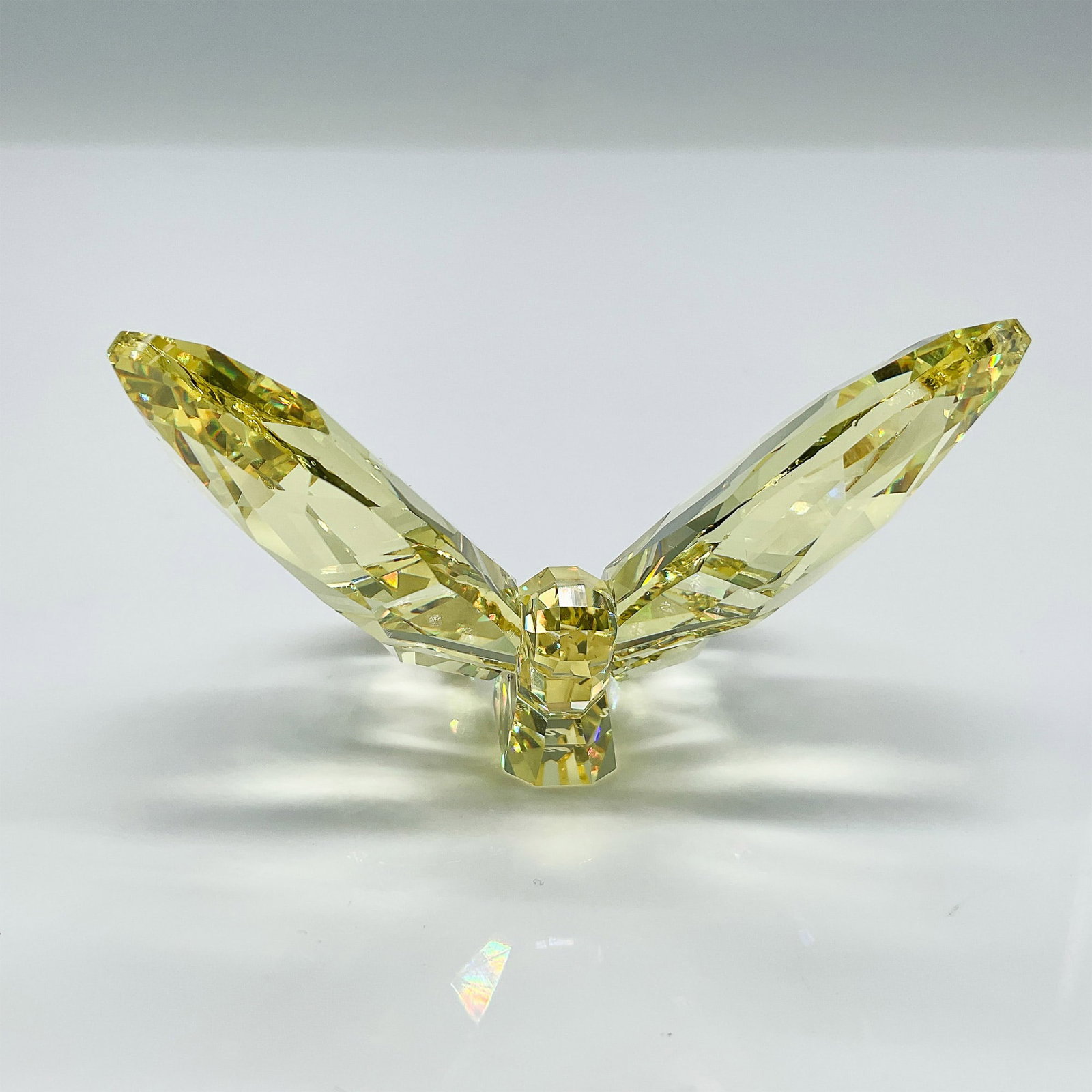 Swarovski Crystal Figurine, Brilliant Butterfly: Swarovski's Oruga Butterfly in vibrant yellow crystal is a dazzling addition to the Lovlots collection. This stunning figurine showcases meticulously faceted wings and a clear crystal body, capturing 
