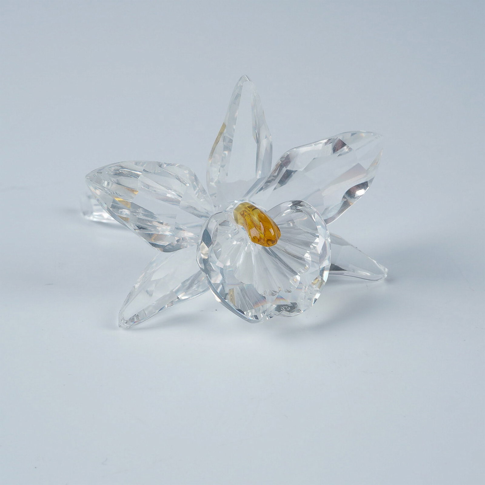 Swarovski Crystal Figurine, Orchid Yellow Dark Centre w/ Box: This Swarovski Crystal Orchid Yellow Dark Centre figurine is a stunning piece from the Exquisite Accents theme group. It features a beautifully faceted clear crystal orchid with a vibrant yellow dark 