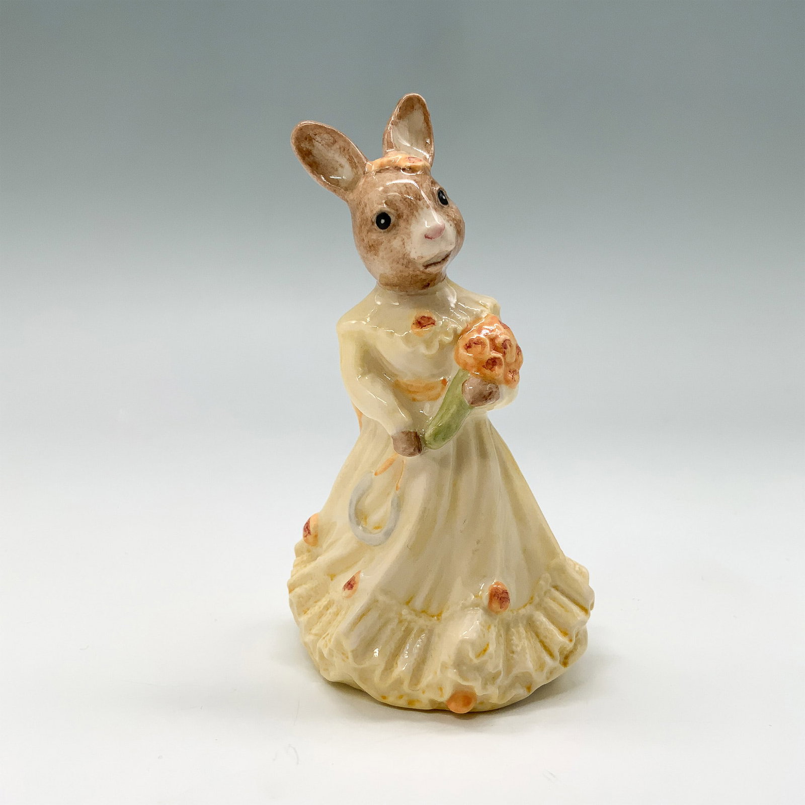 Royal Doulton Bunnykins Figurine, Bridesmaid DB173 w/ Box: Fine bone china Royal Doulton Bunnykins figurine titled Bridesmaid DB173. Features a rabbit in a cream-colored dress holding a bouquet of flowers. Includes the original box. The base is marked with th