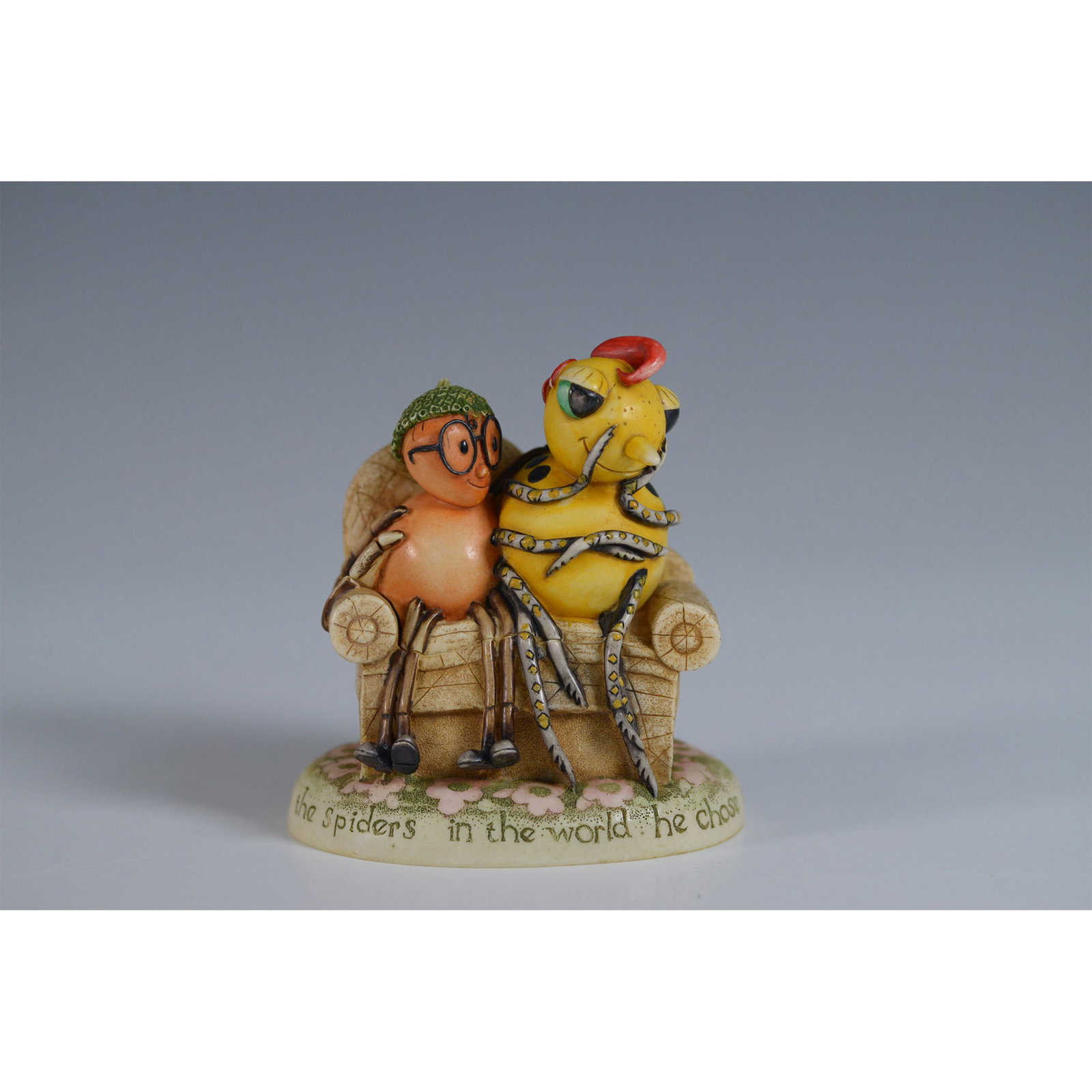 Harmony Kingdom Miss Spider In Love Figurine: This charming figurine, titled Miss Spider In Love, depicts two adorable, hand-painted creatures sitting closely together on a cozy chair, each with distinct, playful expressions. The base of the piec