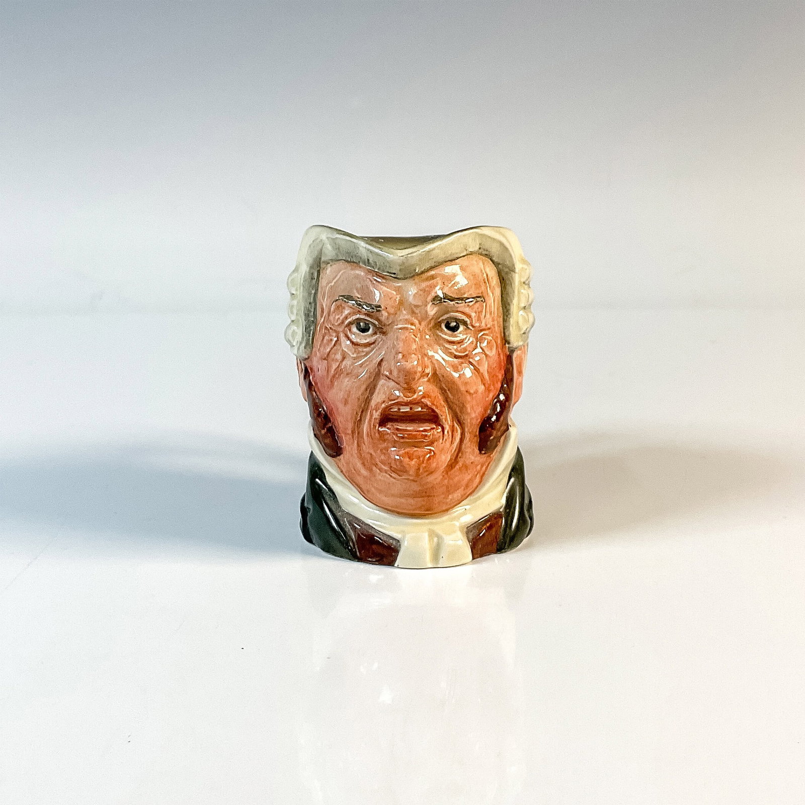 Buz Fuz D5838 - Small - Royal Doulton Character Jug: White collar; brown waistcoat; dark green coat; black robe. Royal Doulton backstamp. Artist: Leslie Harradine and Harry Fenton Issued: 1948 - 1960 Dimensions: 3.25"H Country of Origin: England