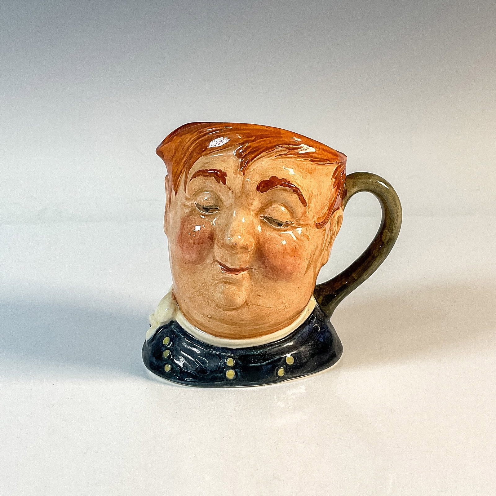 Fat Boy D5840 - Small - Royal Doulton Character Jug: Blue shirt; white scarf. Royal Doulton backstamp. Artist: Leslie Harradine and Harry Fenton Issued: 1948 - 1960 Dimensions: 3.25"H Country of Origin: England