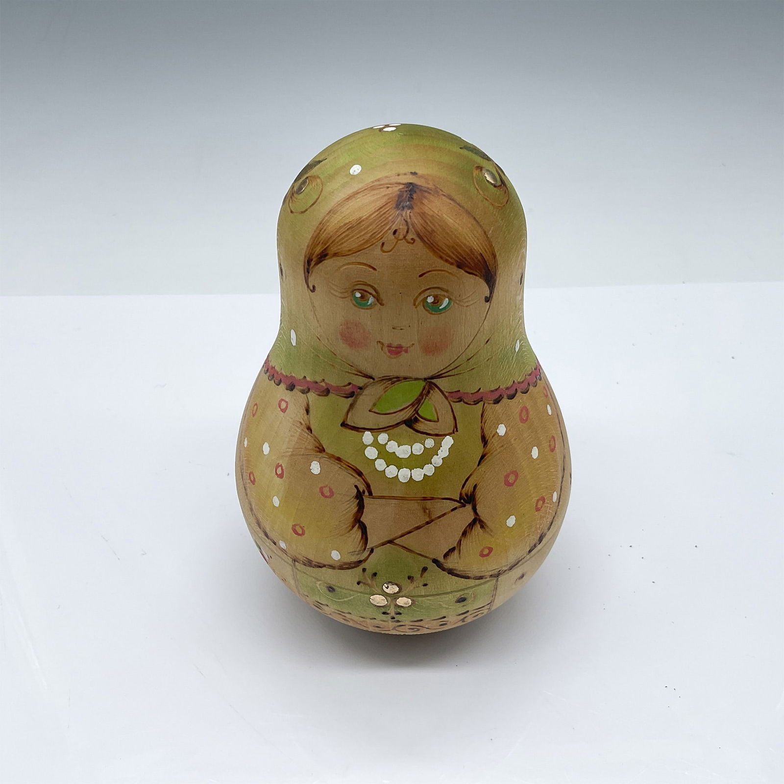 Hand-Painted Wooden Matryoshka Doll: A charming hand-painted wooden Matryoshka doll, standing 5" tall. Unlike traditional nesting dolls, this piece does not open but features a delightful sound inside, reminiscent of a bell. The intricat