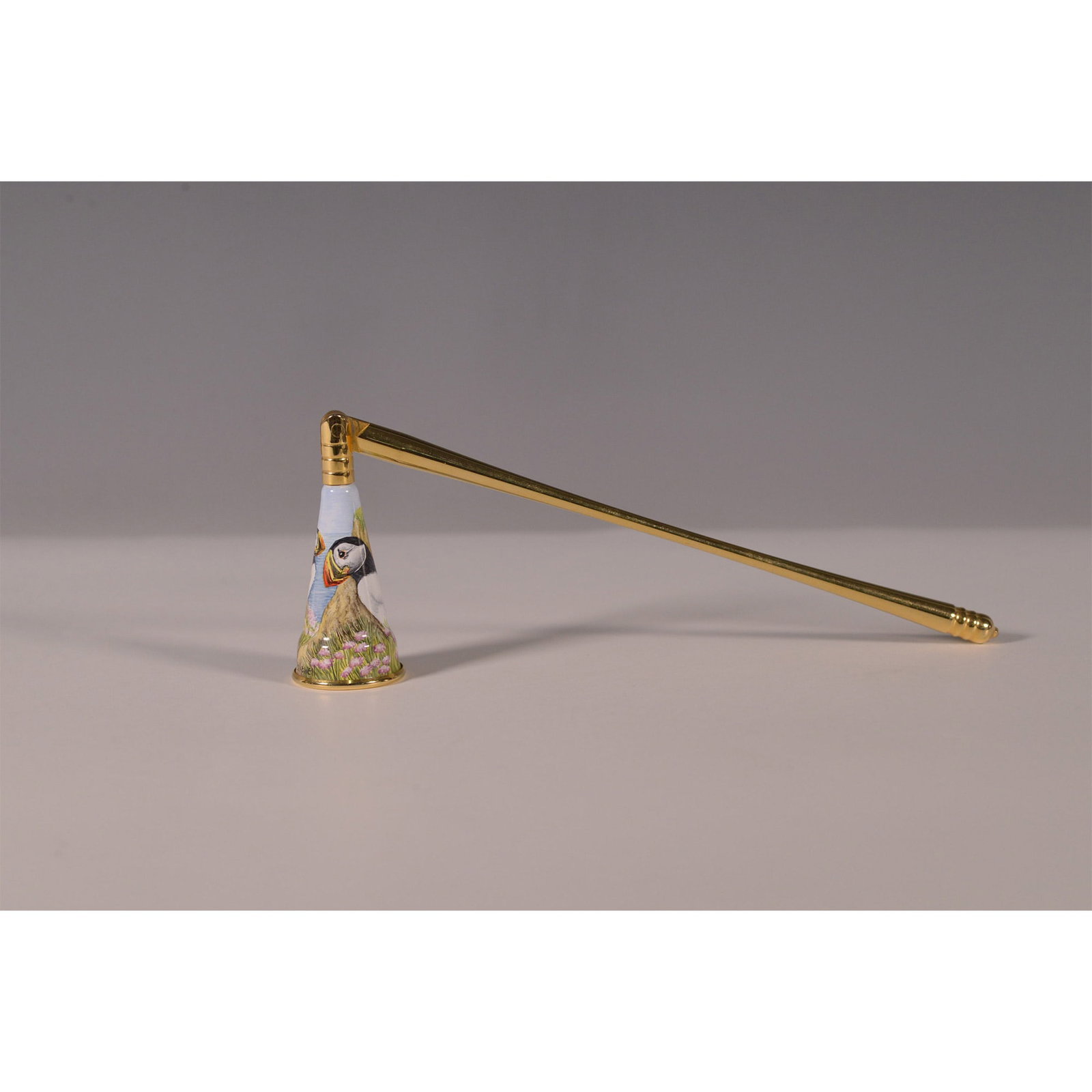 Elliot Hall Enamels Limited Edition Candle Snuffer, Puffin Design: Handcrafted Elliot Hall Enamels candle snuffer featuring a detailed hand-painted puffin design. This limited edition piece is number 10 of 25, adorned with a gold-toned handle and trim. The conical ba