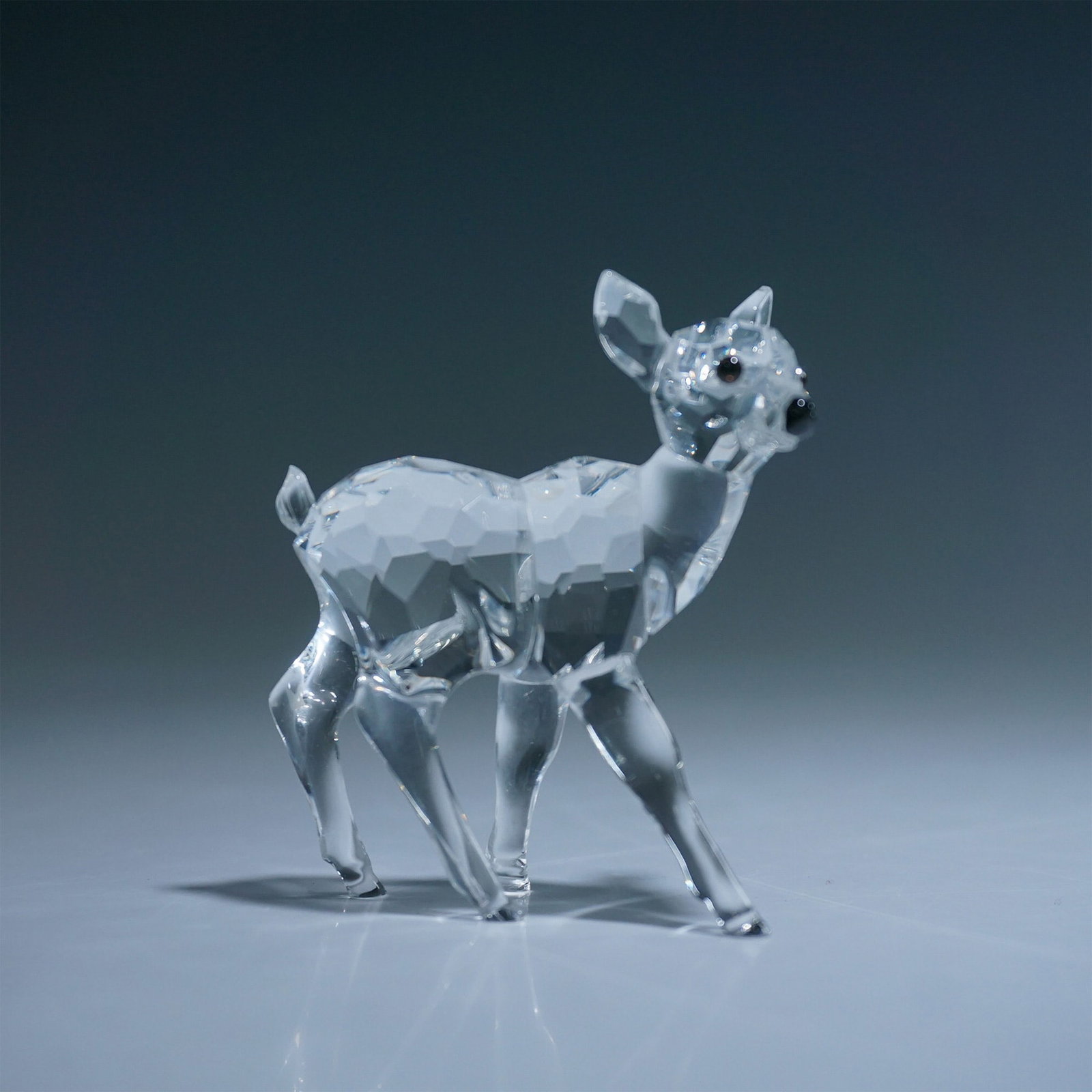 Swarovski Crystal Figurine, Fawn 235045: This Swarovski crystal figurine, Fawn (#235045), was part of the Rare Encounters series. Featuring a faceted clear crystal body with black eyes and nose, this delicate fawn captures the beauty of natu