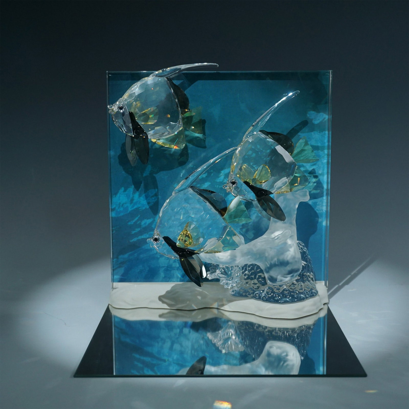 Swarovski Crystal Wonders of the Sea, Community with Plaque: The Wonders of the Sea, Community Swarovski crystal sculpture is beautifully presented with three intricately detailed fish, crafted from high-quality crystal with yellow and black accents. The scene 