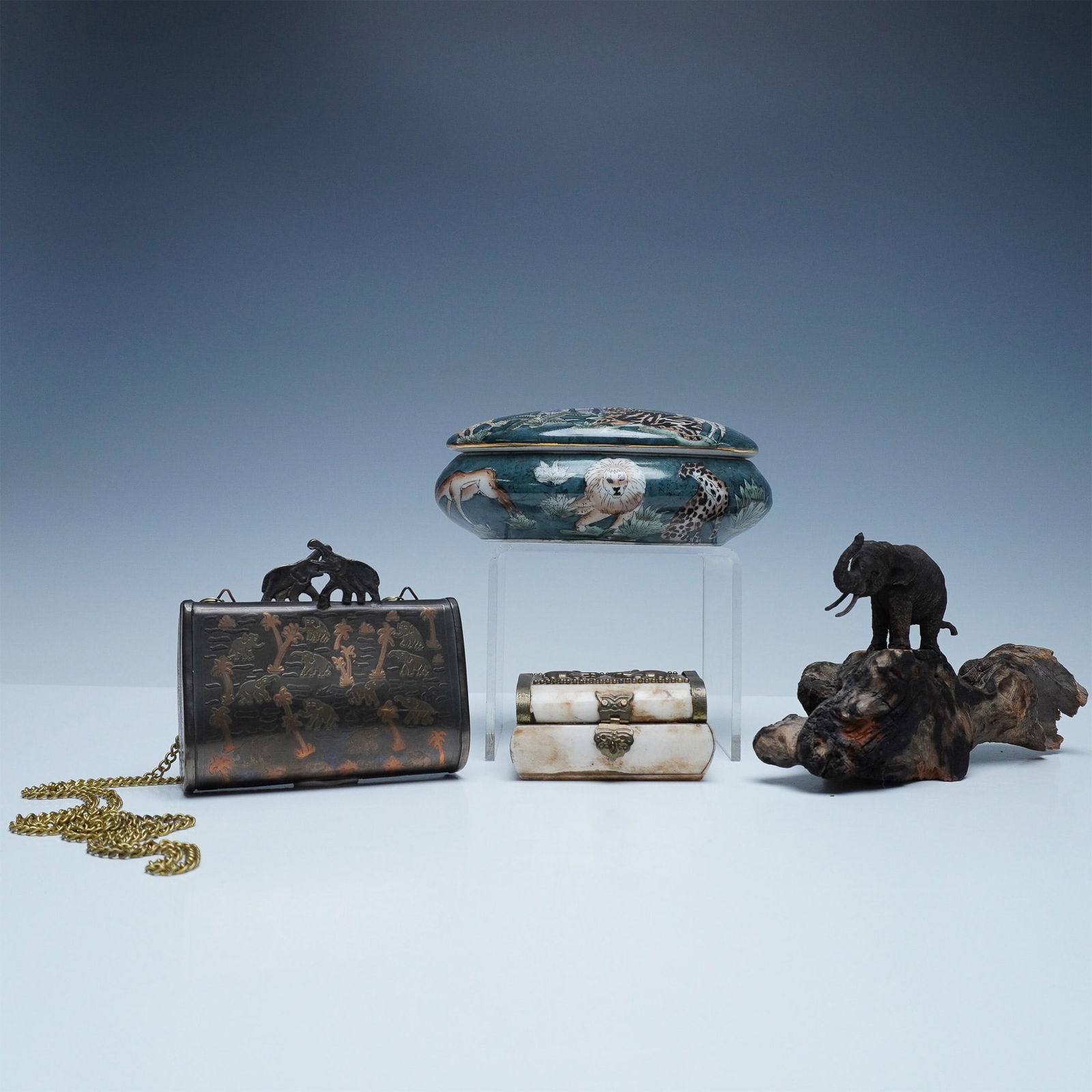 4pc Wildlife-Themed Decorative Boxes and Elephant Figurine: This collection features four wildlife-inspired decorative pieces, each showcasing intricate craftsmanship and unique materials. The hand-painted porcelain box is oval-shaped, adorned with a rich gree