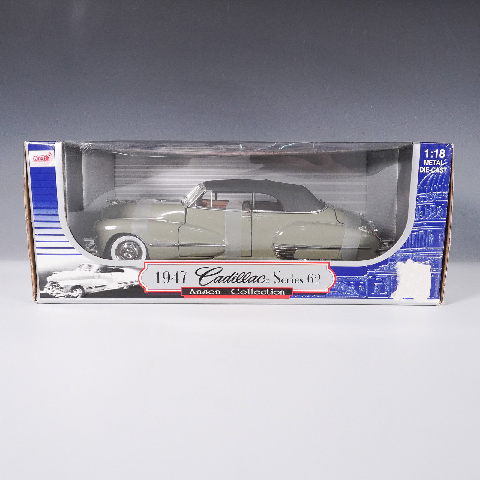 Anson 1947 Cadillac Series 62 Die Cast Model Car: Anson 1:18 scale die cast model of a 1947 Cadillac Series 62 featuring a detailed interior and exterior with opening doors, hood, and trunk. The model is finished in a gray body with a black hood, acc