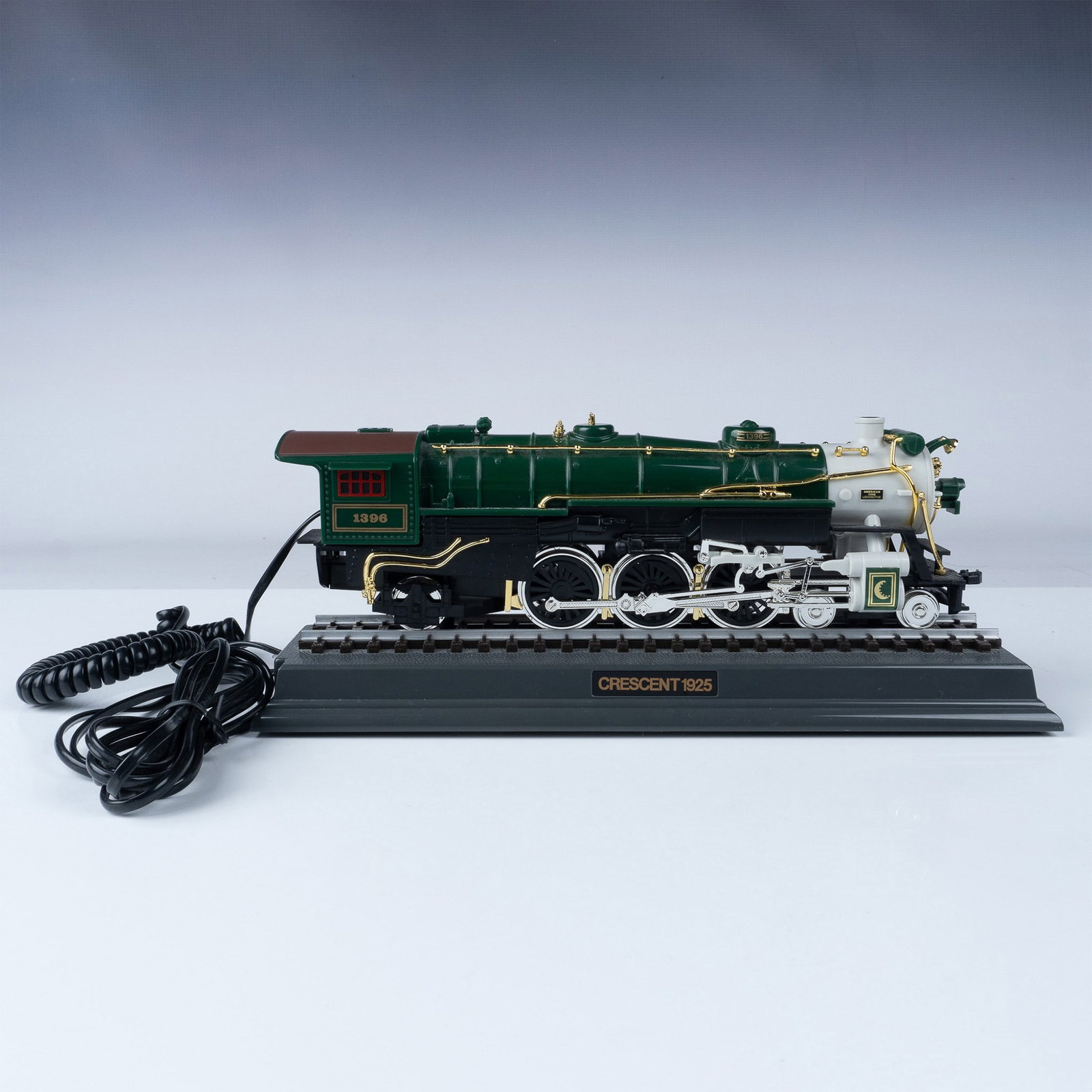 Vintage Crescent 1925 Locomotive Train Telephone: This unique Crescent 1925 locomotive-shaped telephone combines vintage charm and functionality. Modeled after a classic steam engine, the green and white train features intricate detailing, including 