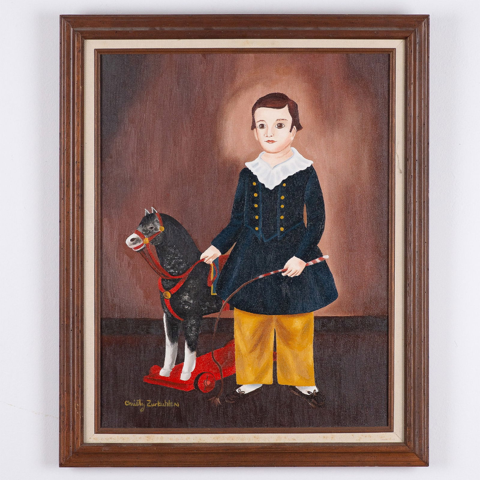 Christy Zurkuhlen Folk Art Painting of Boy with Toy Horse: Original painting by Christy Zurkuhlen depicting a boy dressed in traditional attire holding a toy horse on a red pull wagon. The artwork reflects Zurkuhlen's signature folk art style, characterized b