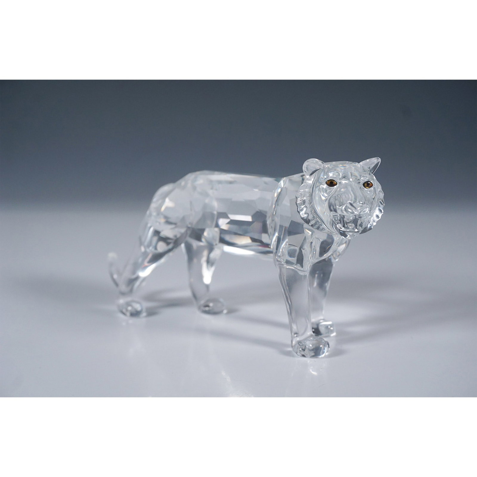 Swarovski Crystal Tiger Figurine: Magnificent Swarovski crystal tiger figurine, model number 220470, designed by Michael Stamey. This exceptional piece was introduced in 1998 and retired in 2002 as part of the Swarovski Endangered Wil