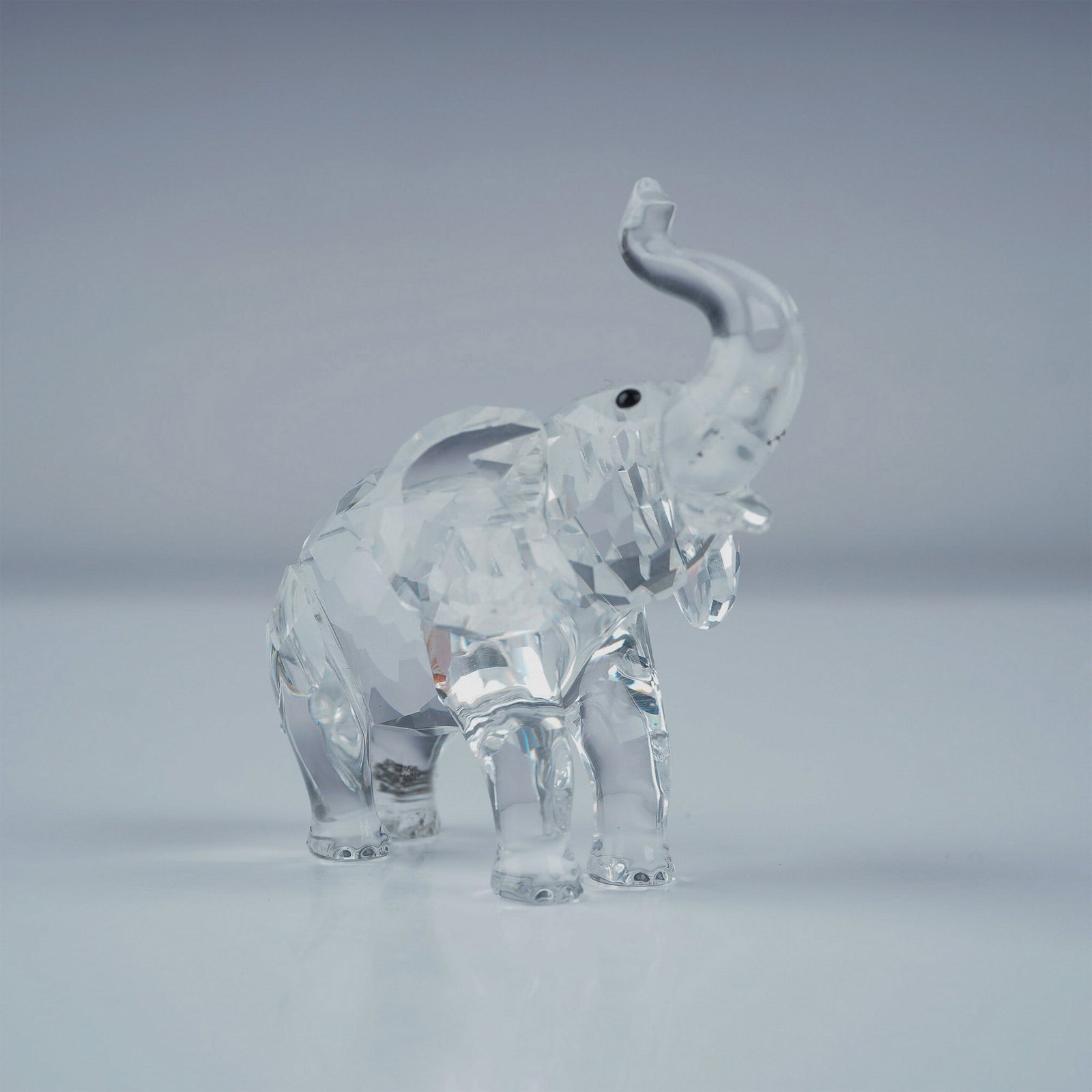 Swarovski Crystal Figurine, Baby Elephant: Charming Swarovski crystal figurine of a baby elephant from the Rare Encounters theme group. Crafted in faceted clear crystal, this adorable piece captures the innocence of a young elephant with expre