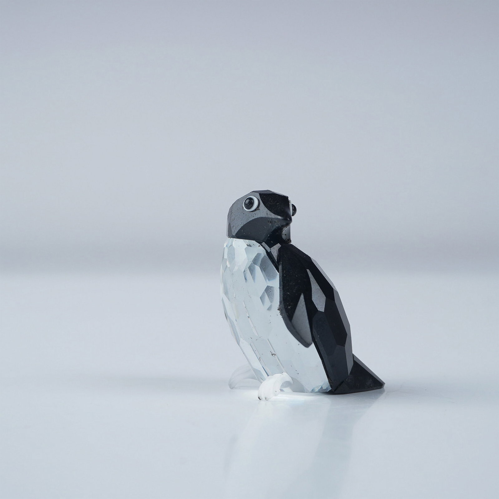 Swarovski Crystal Figurine, Penguin Madame: Swarovski Crystal Figurine, Penguin Madame, part of the Kingdom of Ice and Snow collection. Crafted from clear and black faceted crystal, this charming penguin features white crystal accents around it
