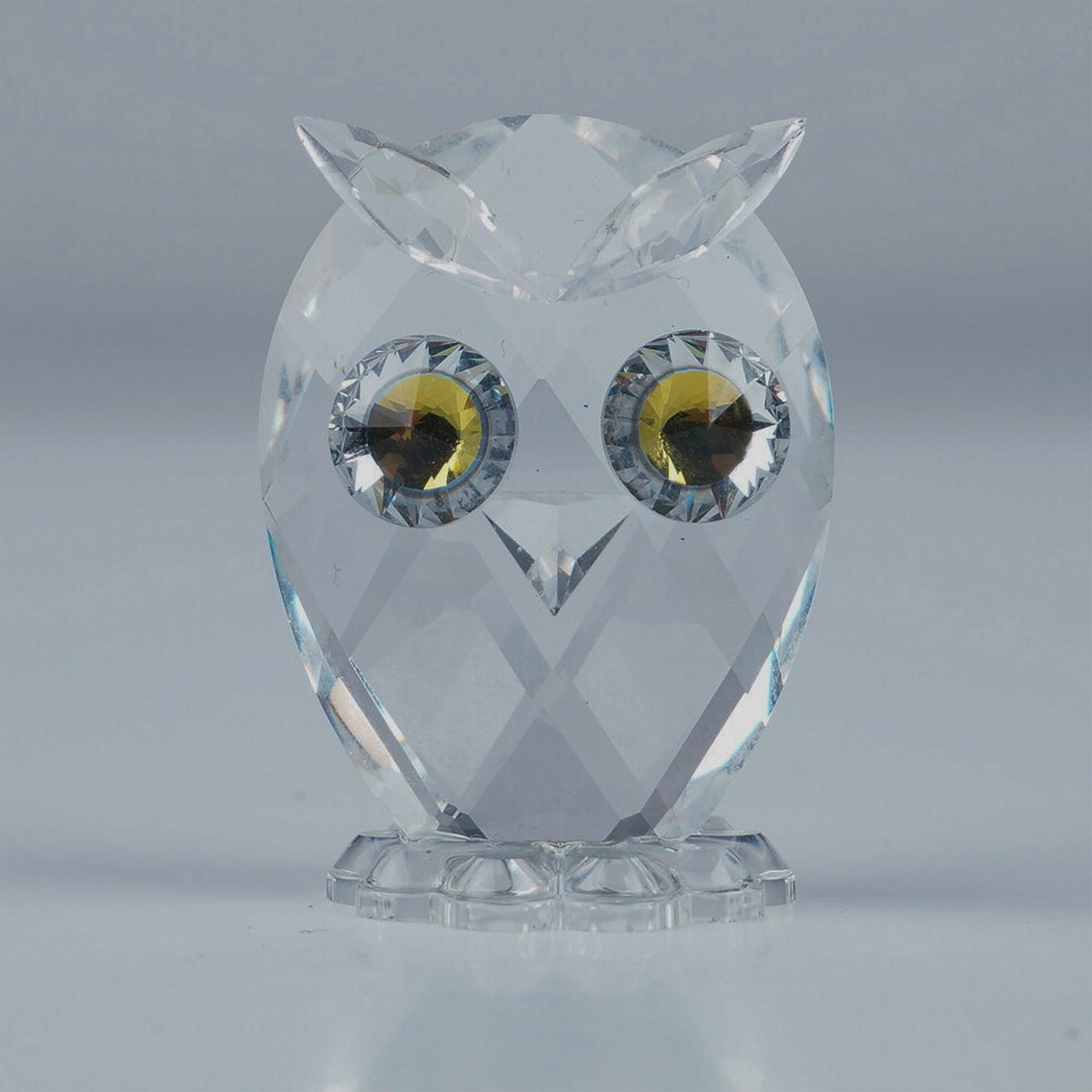 Swarovski Crystal Figurine, Mini Owl with Box: A charming Swarovski Crystal Mini Owl figurine from the Woodland Friends collection, later part of the Feathered Beauties theme group. This faceted clear crystal owl features striking Citron crystal e