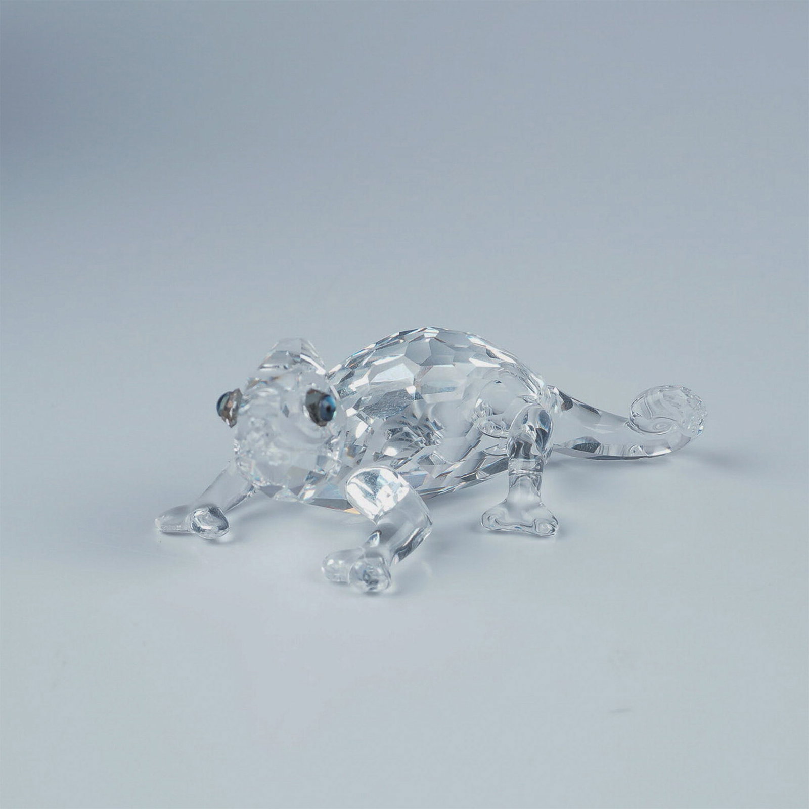 Swarovski Crystal Figurine, Chameleon with Box: Swarovski crystal figurine, Chameleon, a member of the Rare Encounters theme group. This exquisite piece features a faceted clear crystal body with striking Cantaloupe crystal eyes. Marked with the Sw