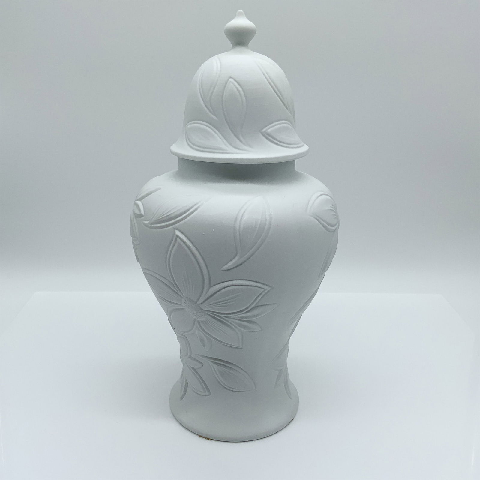 Royal Porzellan Bavaria KPM Porcelain Jar: Matte white porcelain jar with floral relief design and domed lid. Marked Royal Porzellan Bavaria KPM, Made in West Germany. Issued: 20th century Dimensions: 11"H Country of Origin: Germany