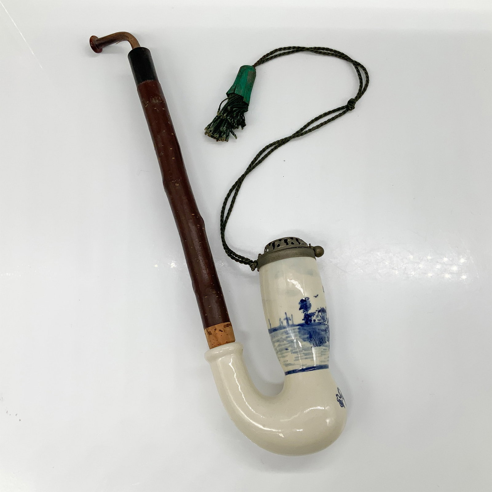 Delft Porcelain and Wood Tobacco Pipe with Metal Lid: Delft-style porcelain and wood tobacco pipe featuring a blue and white scenic transfer design. The porcelain bowl showcases a classic Dutch landscape, including a windmill and waterway, while the wood