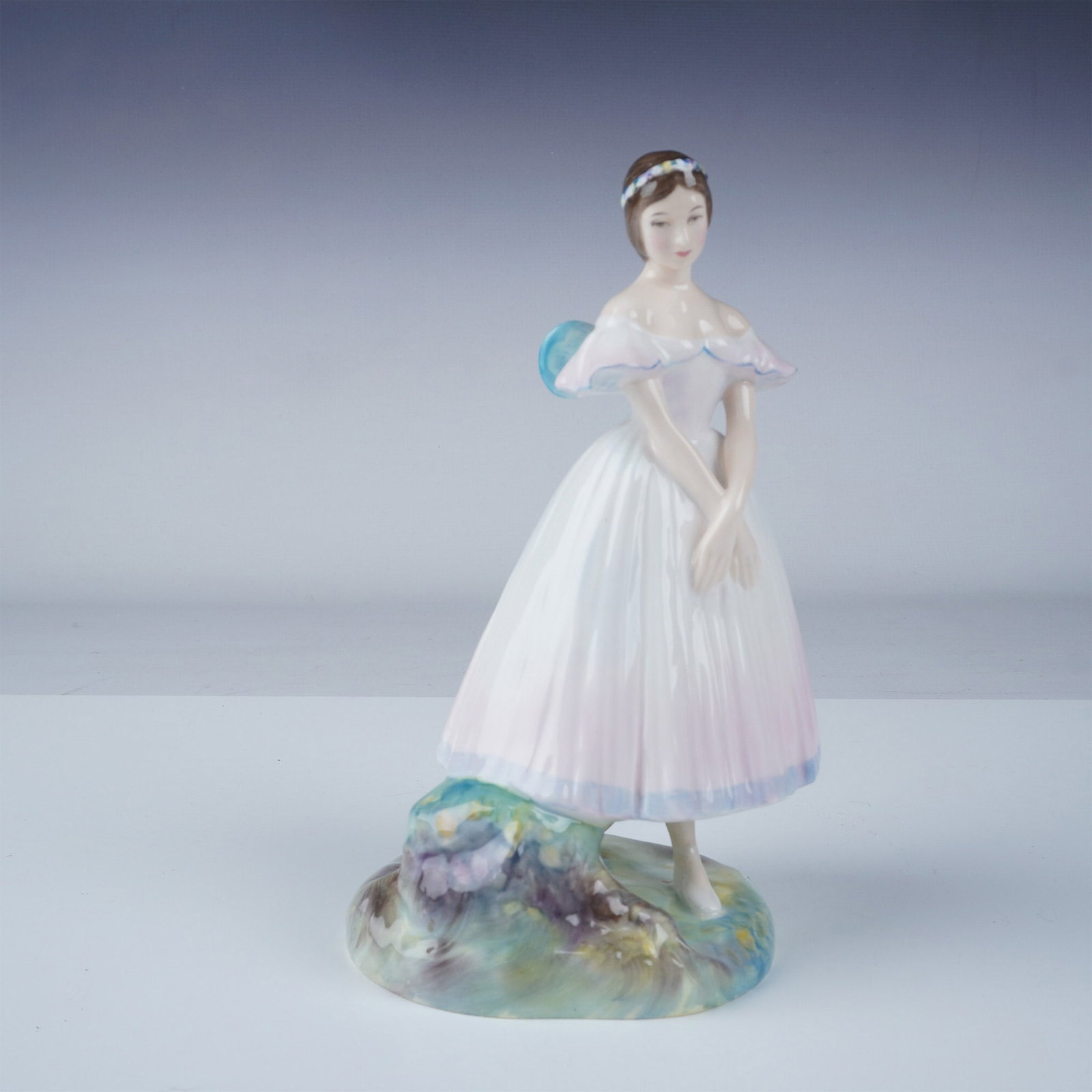 Royal Doulton Figurine, La Sylphide HN2138: A Royal Doulton figurine titled La Sylphide, model number HN2138, featuring a graceful ballerina in an elegant off-the-shoulder gown with pastel accents. This porcelain figurine is part of the Whitley