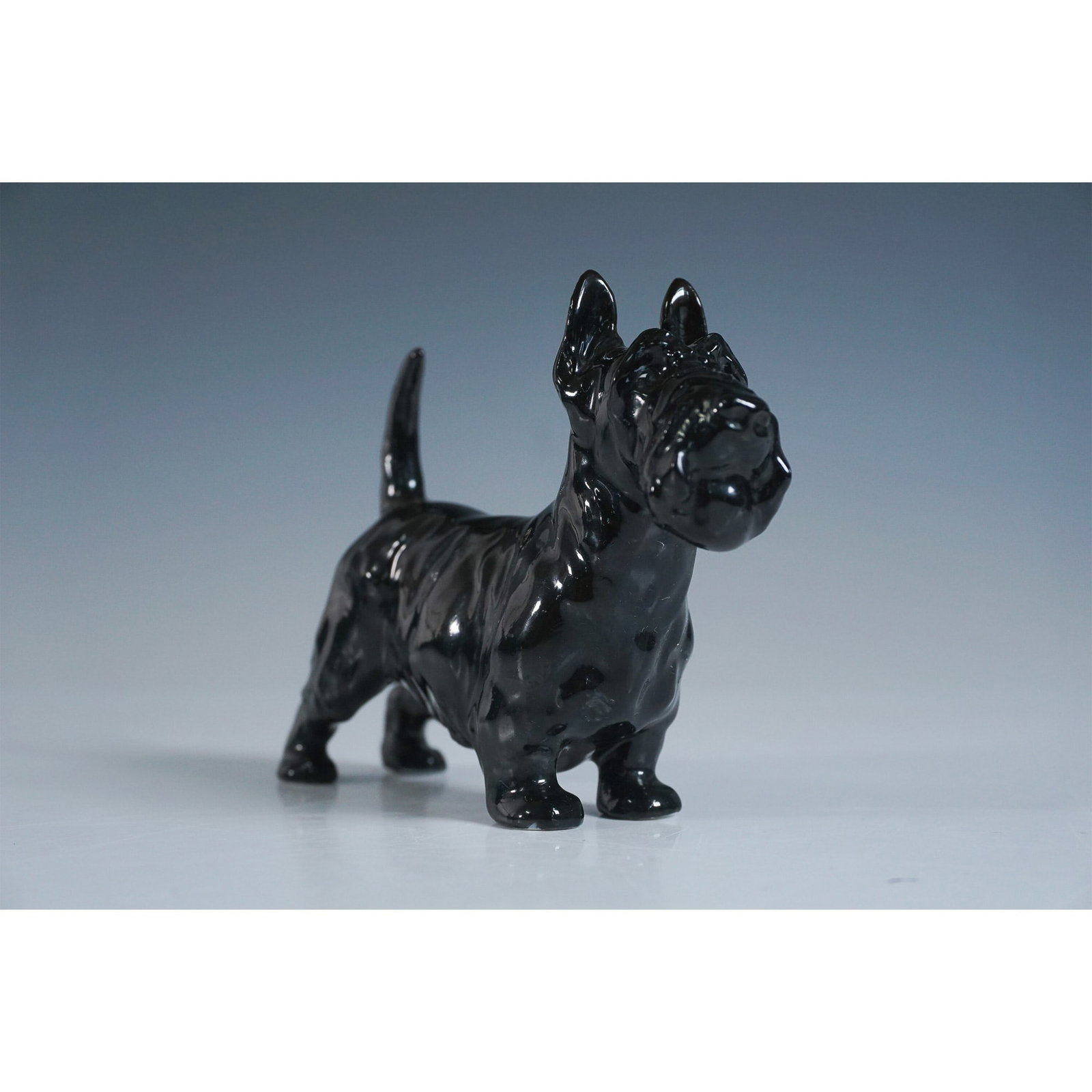 Royal Doulton Figurine, Black Scottish Terrier with Box: Charming Royal Doulton figurine depicting a black Scottish Terrier, measuring 3.5"H. The figurine features the Royal Doulton backstamp on the underside, ensuring authenticity. Accompanied by the origi