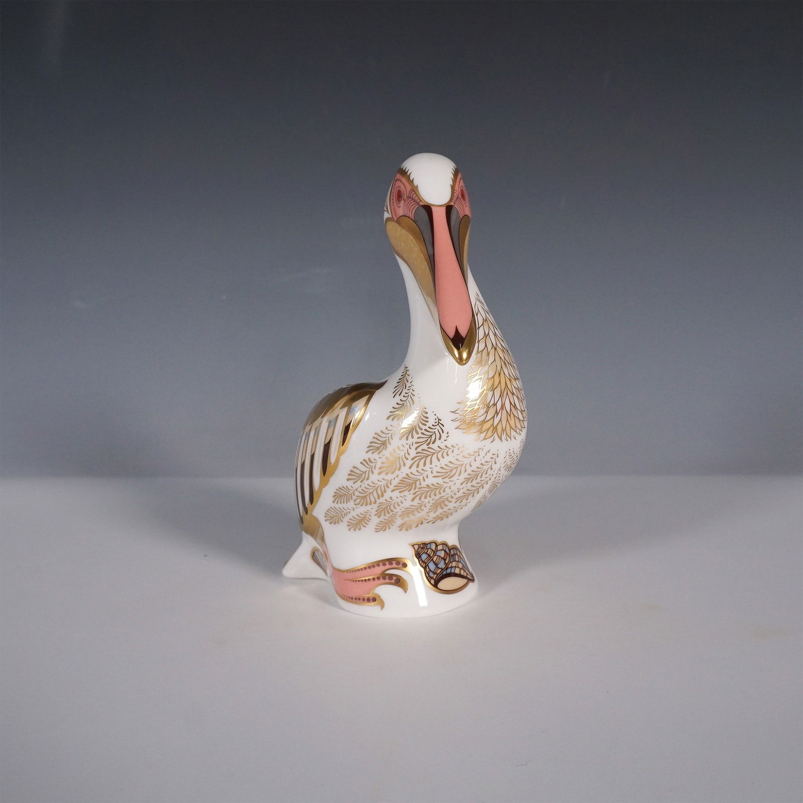 Royal Crown Derby White Pelican Paperweight Limited Edition: Exquisite Royal Crown Derby fine bone china paperweight in the form of a White Pelican, part of the brand's highly collectible paperweight series. This limited edition piece, numbered 1009 from a run