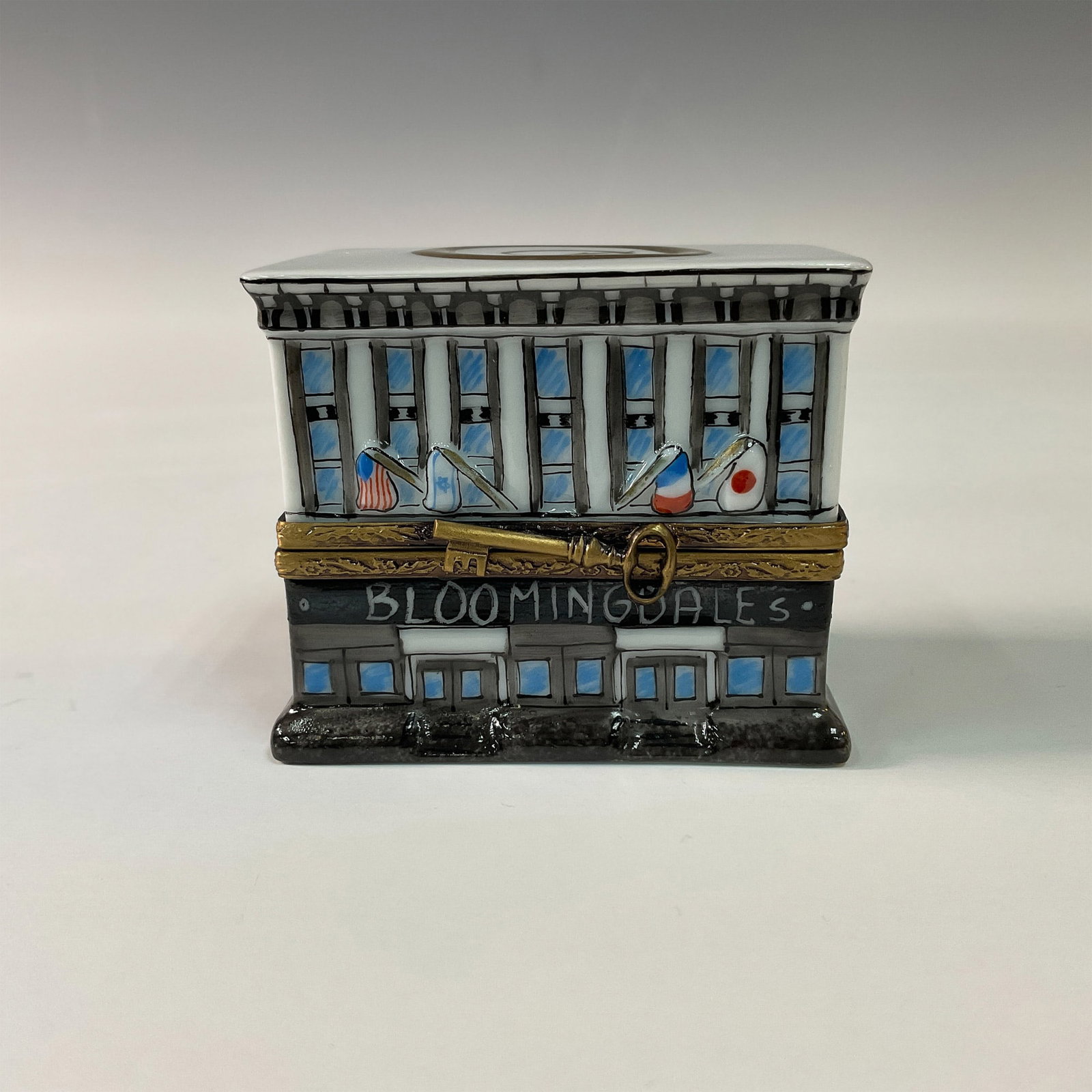 Exclusive Limoges French Bloomingdale's Collectible Box: A porcelain treasure box, handcrafted in Limoges, France, and made exclusively for Bloomingdale's. This limited edition piece is beautifully depicted as the iconic Bloomingdale's flagship store locate