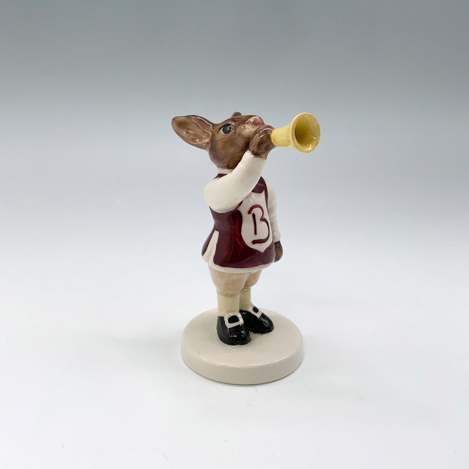 Royal Doulton Bunnykins Figurine, Harry the Herald DB49: Royal Doulton Bunnykins figurine titled Harry the Herald, model number DB49, with its original box. This charming hand-painted porcelain figurine features a herald bunny dressed in a regal maroon and 