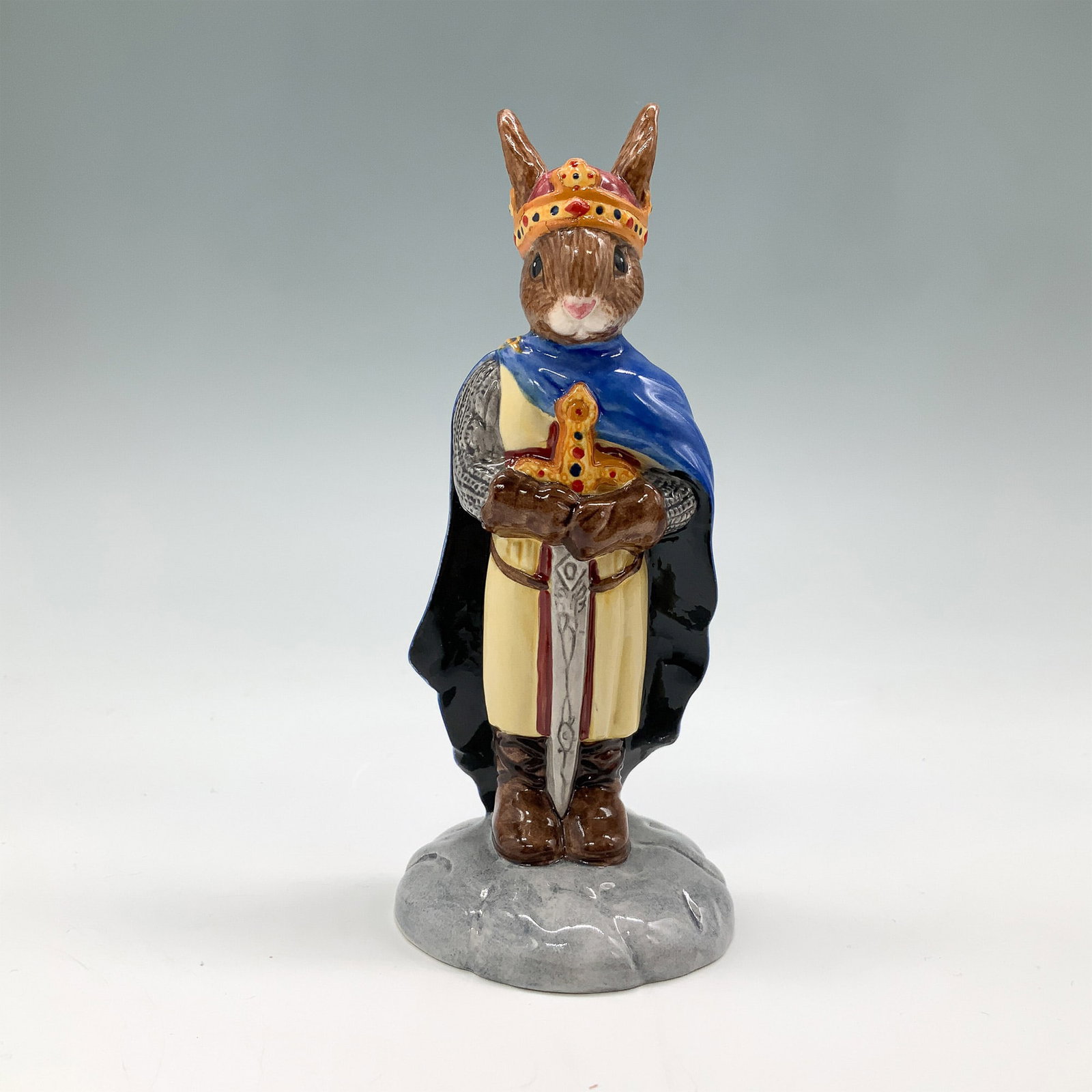 Royal Doulton Bunnykins Figurine, King Arthur DB304 with Box: This charming King Arthur figurine from the Royal Doulton Bunnykins series depicts the legendary king in traditional attire, complete with sword and crown. The piece is hand-painted in a palette of ro