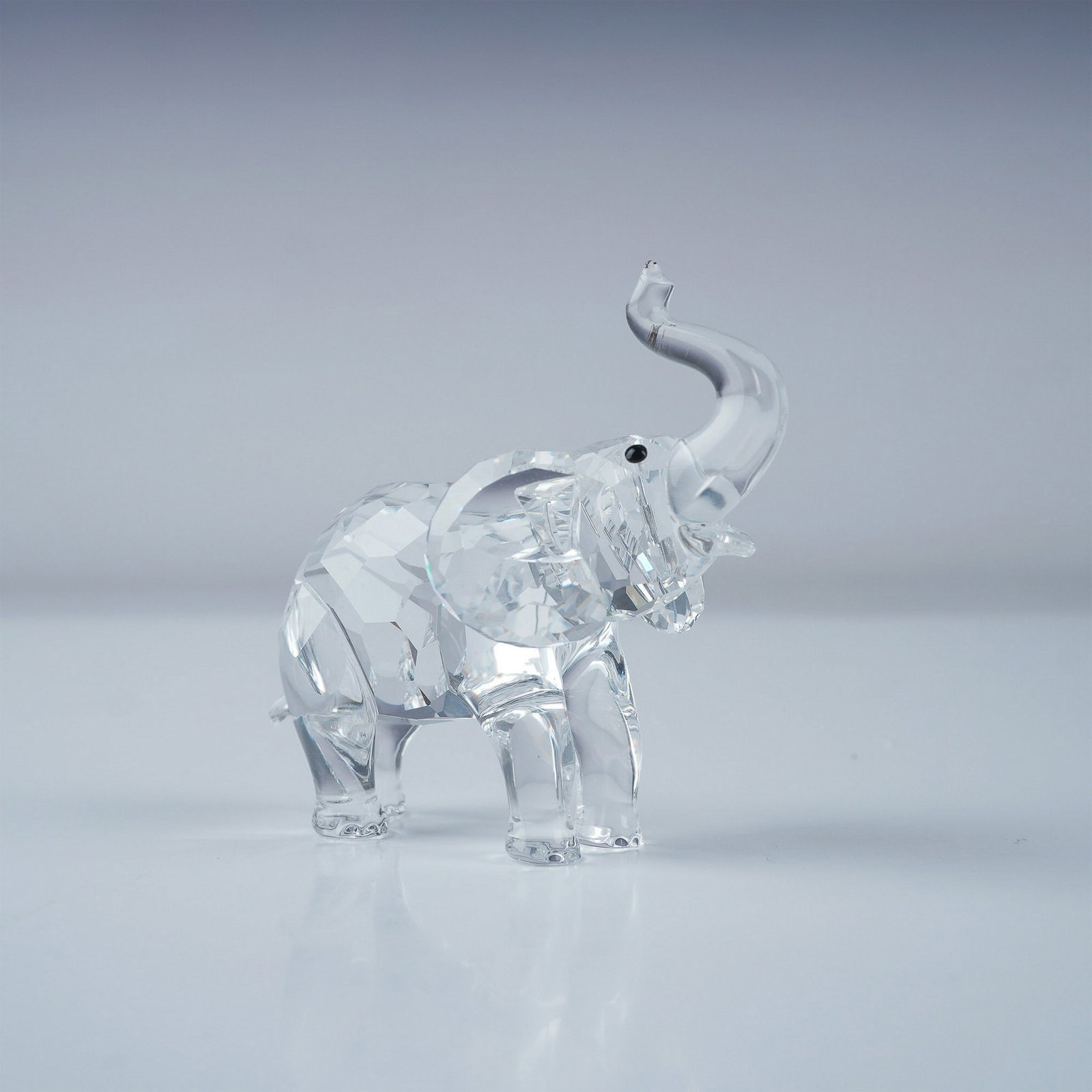 Swarovski Crystal Figurine, Baby Elephant: Swarovski crystal figurine featuring the Baby Elephant from the Rare Encounters theme group. This charming piece is crafted in faceted clear crystal, capturing the innocence and grace of the young ele
