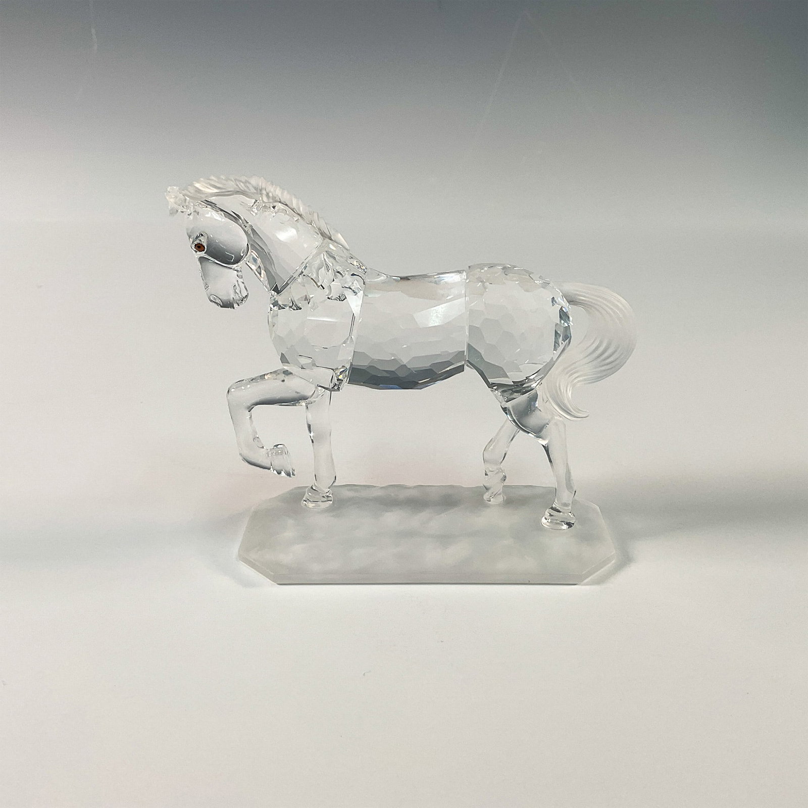Swarovski Crystal Figurine, Arabian Stallion: Part of the Horses on Parade group. This Swarovski Crystal figurine features the majestic Arabian Stallion, a stunning representation of grace and elegance. Crafted with precision, the piece highlight