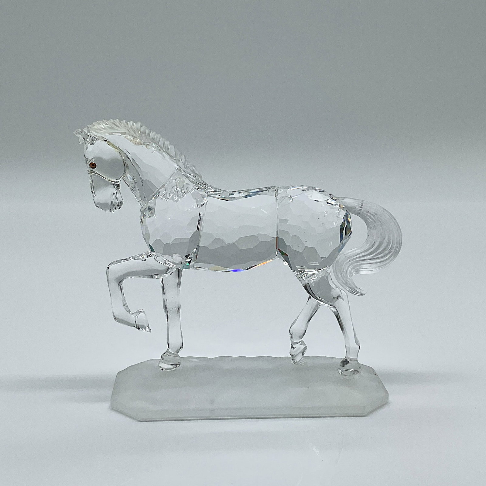 Swarovski Crystal Figurine, Arabian Stallion 221609: This retired Swarovski crystal figurine, the Arabian Stallion, was part of the renowned ?Horses on Parade? collection. Designed by Martin Zendron, the figurine showcases the elegance of a dressage mov