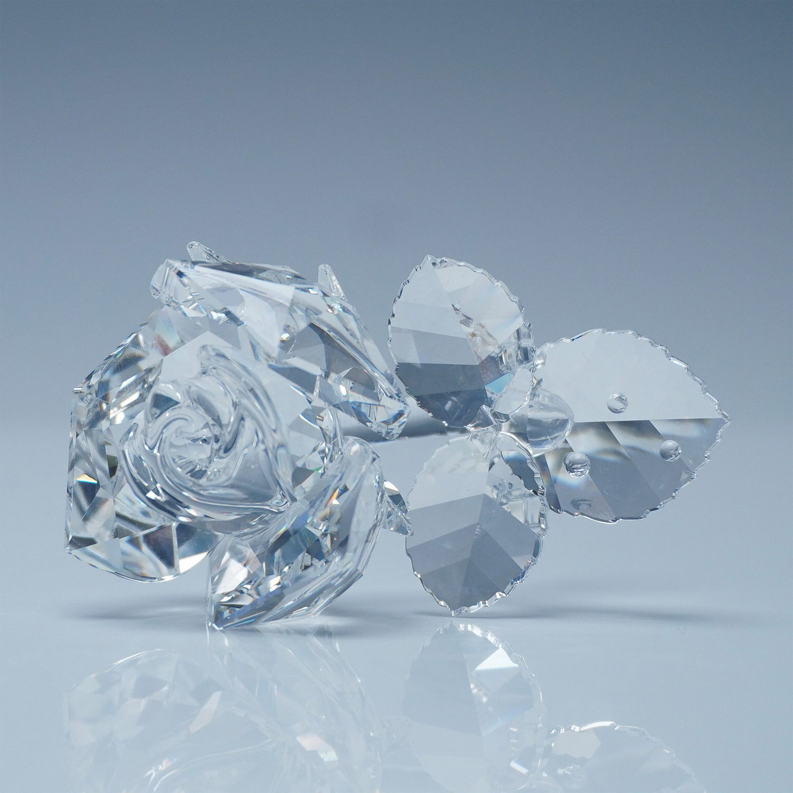 Swarovski Silver Crystal Rose Figurine: This elegant Swarovski Silver Crystal Rose figurine showcases the brand's signature precision-cut crystal craftsmanship. Featuring a beautifully faceted bloom with delicately detailed leaves, this tim